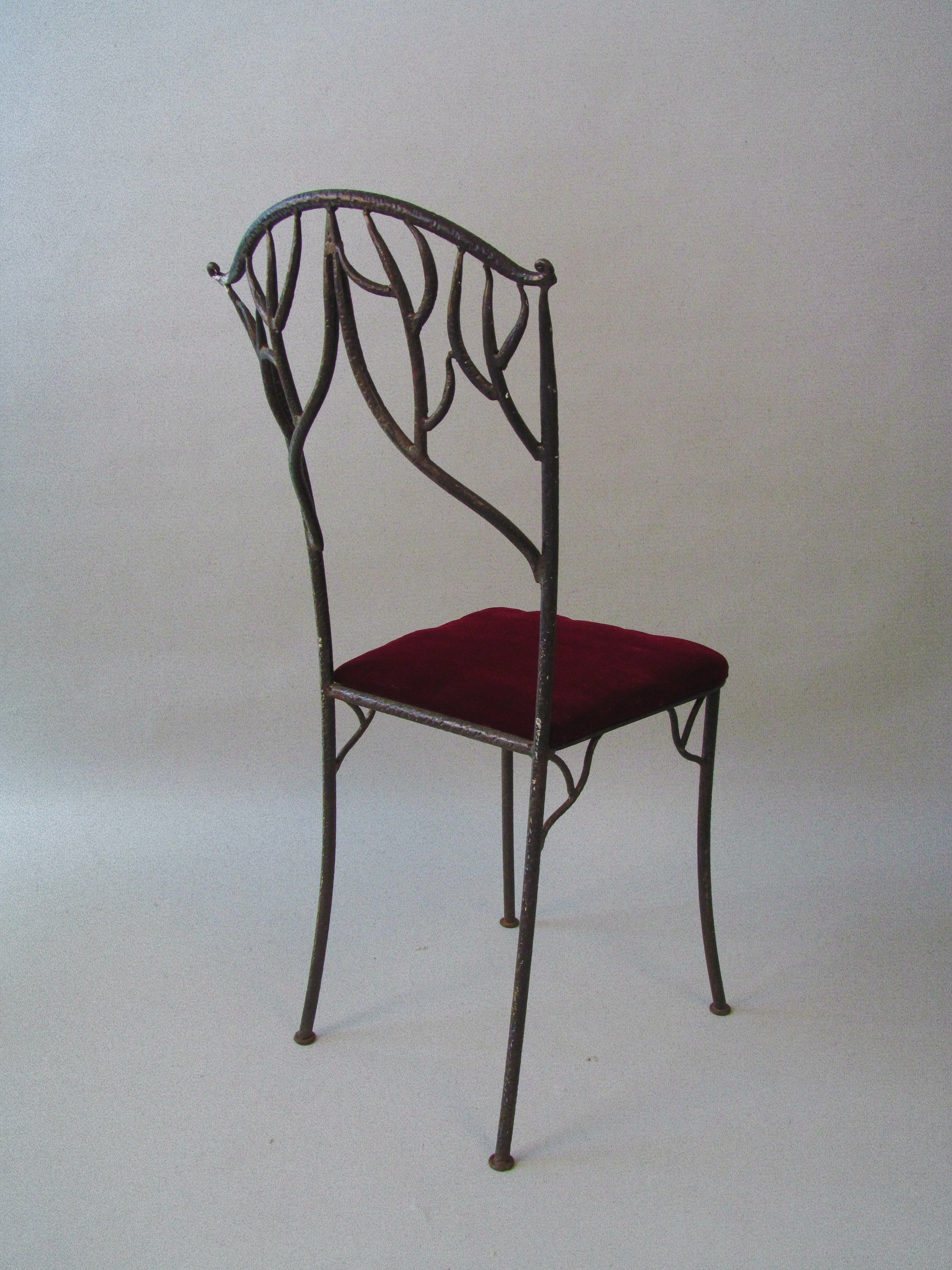 Fer Forgé Dining Chairs (Pair) — side view highlighting wrought iron frame and burgundy seat