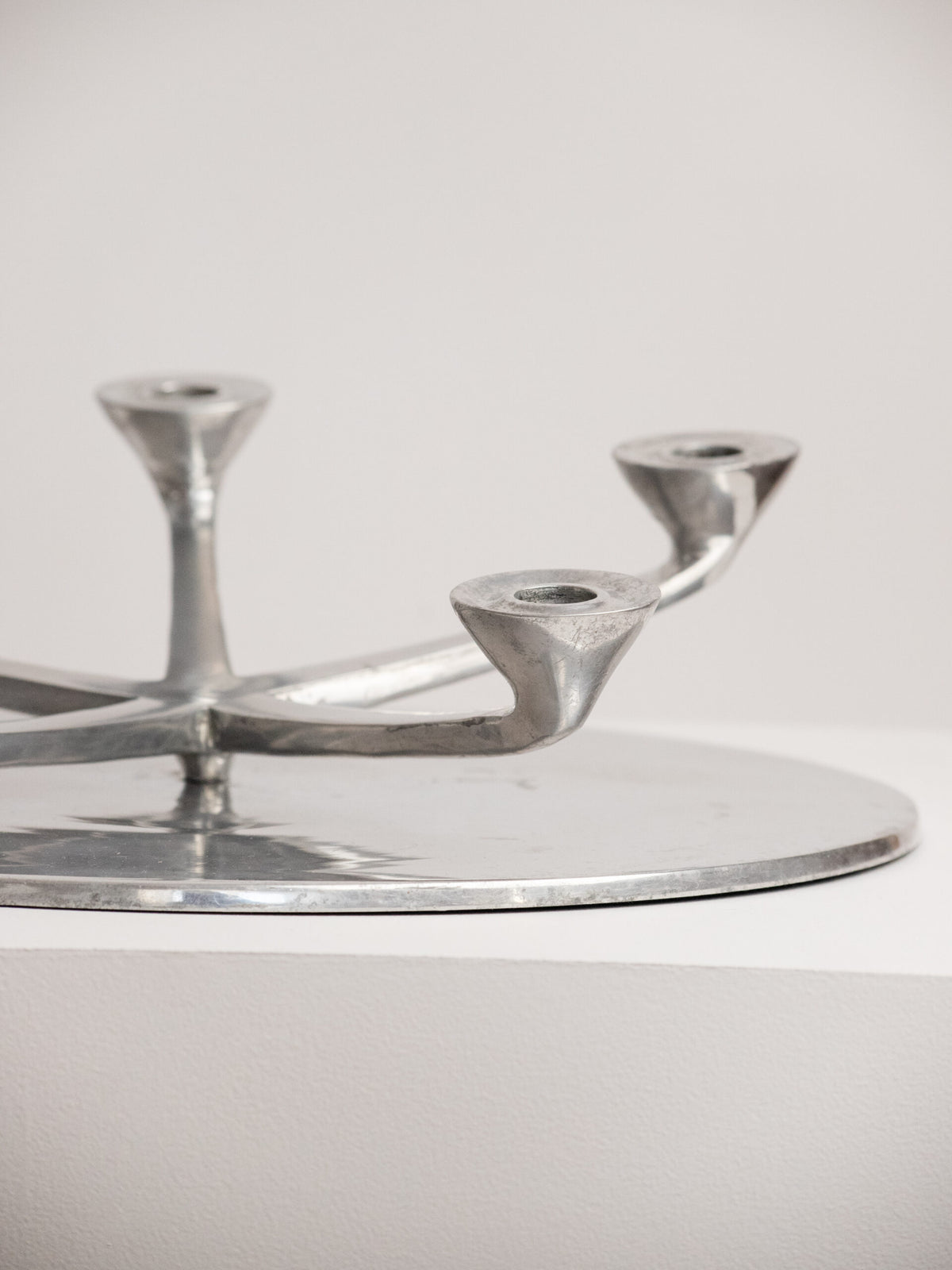 Rotating Five Arm Star Candleholder in Sand Cast Aluminium, Brutalist Europe 1960s to 1970s — lifestyle setting