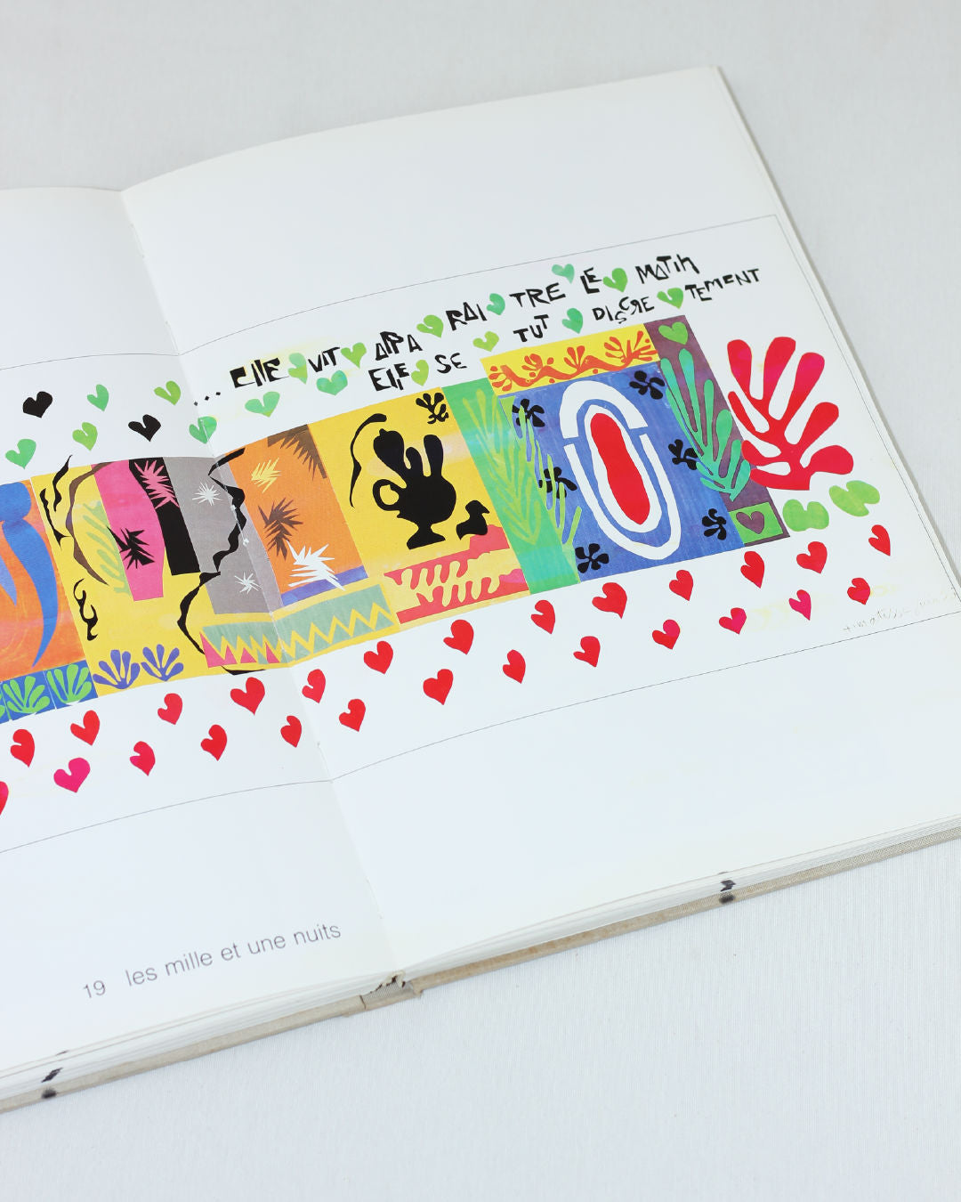 Matisse Paper Cutouts — open book view with colorful cutouts on pages