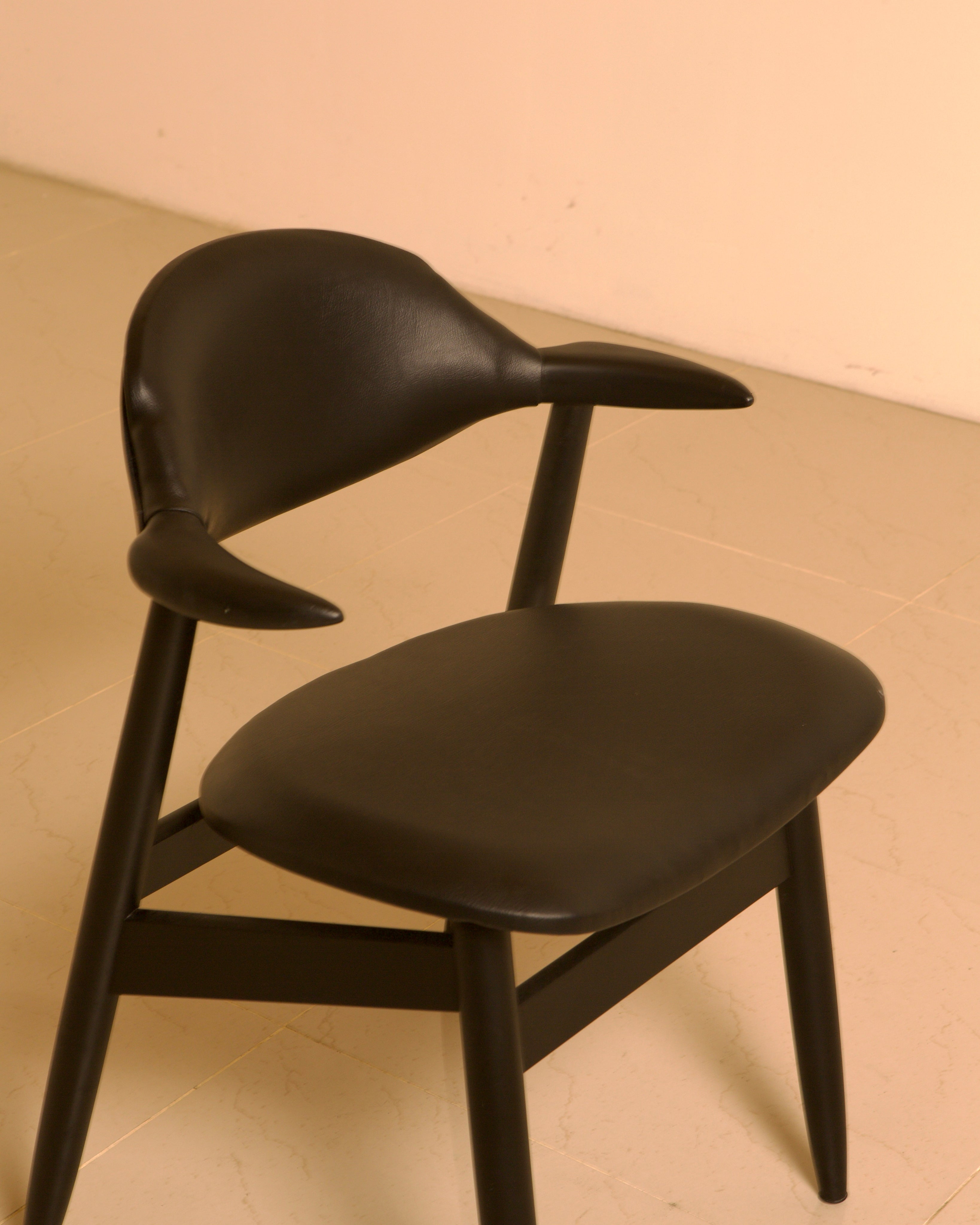 Dutch "Buffalo" Armchair in Wood and Black leather, 1960s — side angle highlighting black leather seat and curved backrest