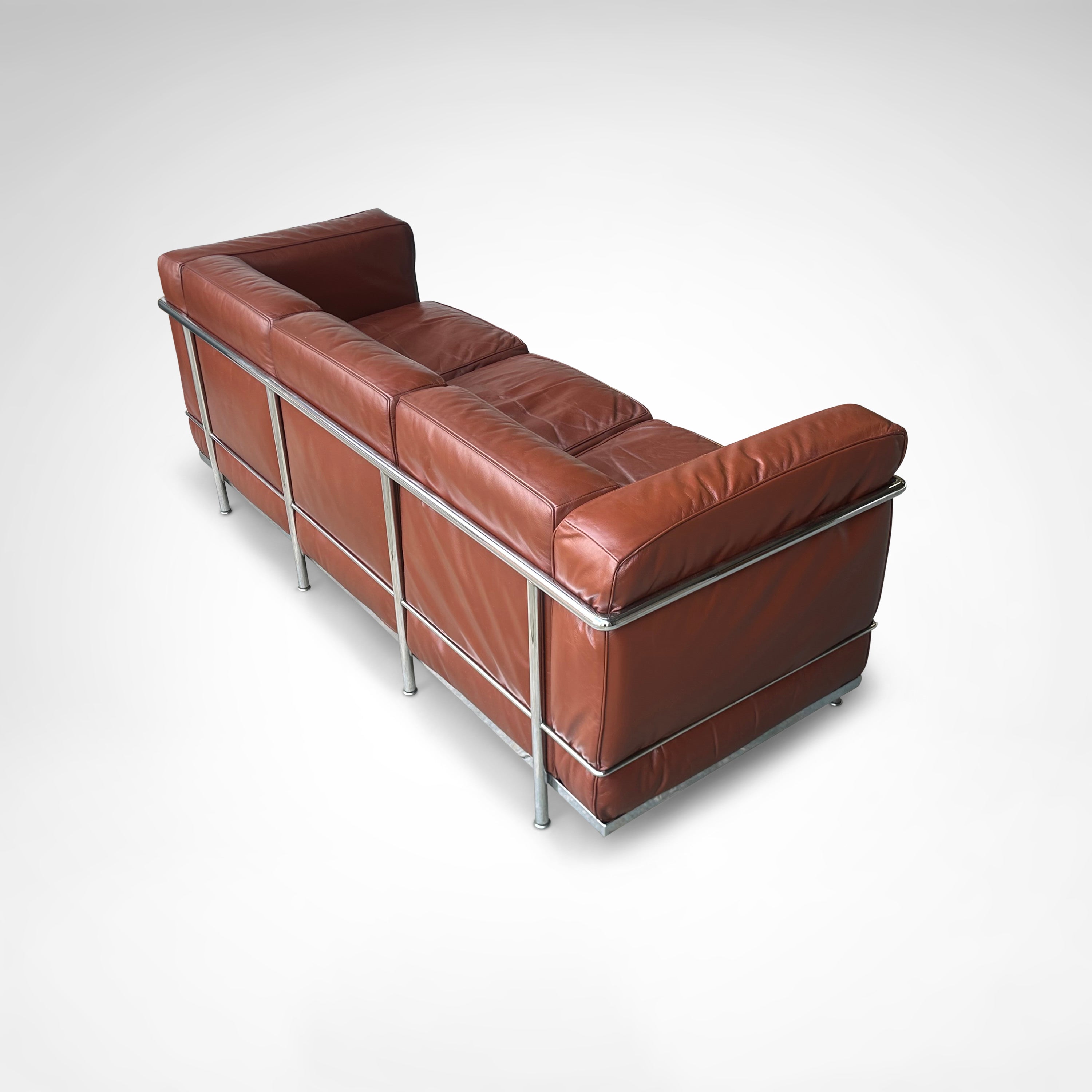 Early production LC2 leather 3-seater sofa by Le Corbusier et al Cassina 1970s — angled view highlighting rich brown leather