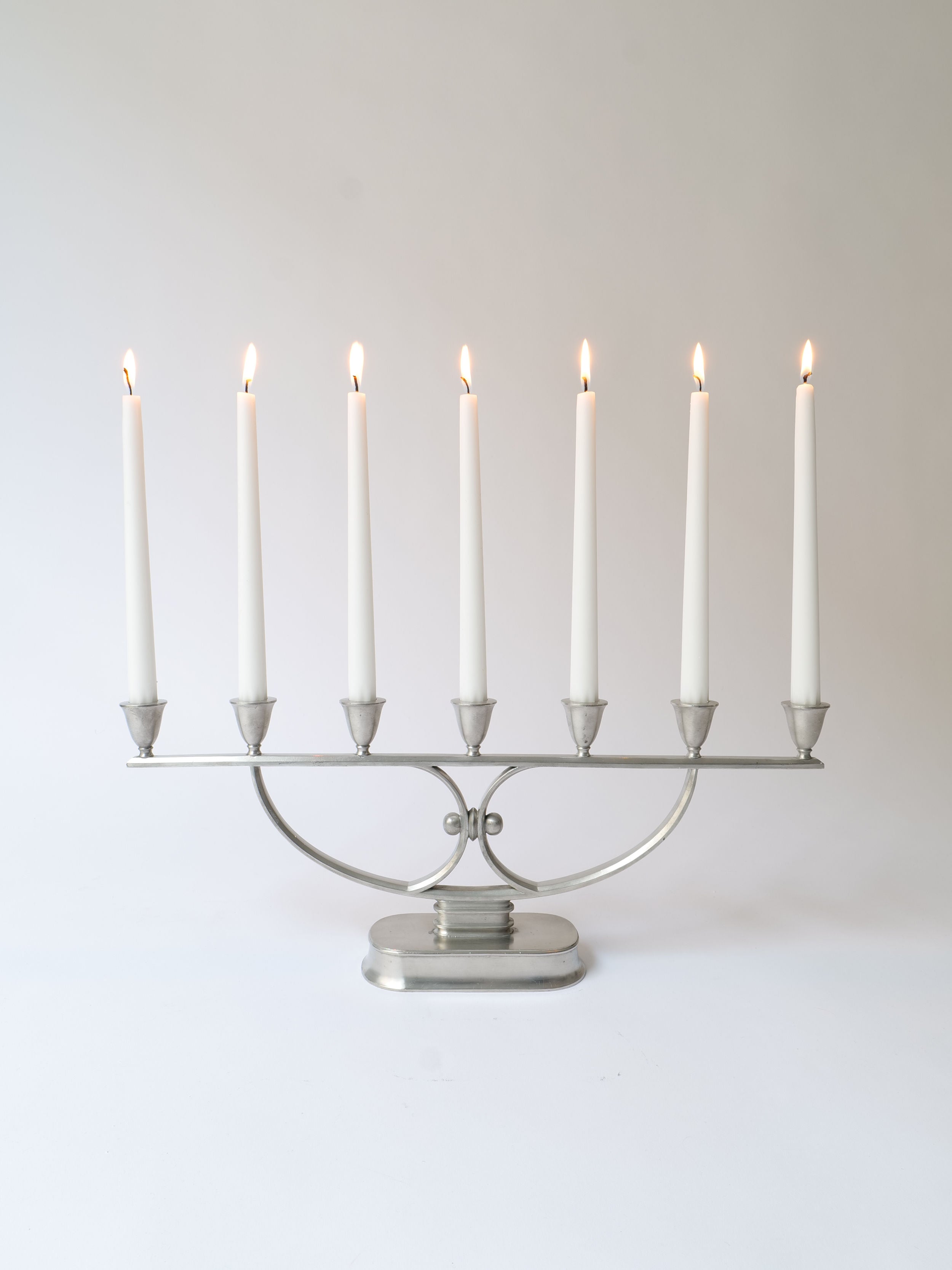Just Andersen Candelabra 1930s — silver metal candelabra with lit candles