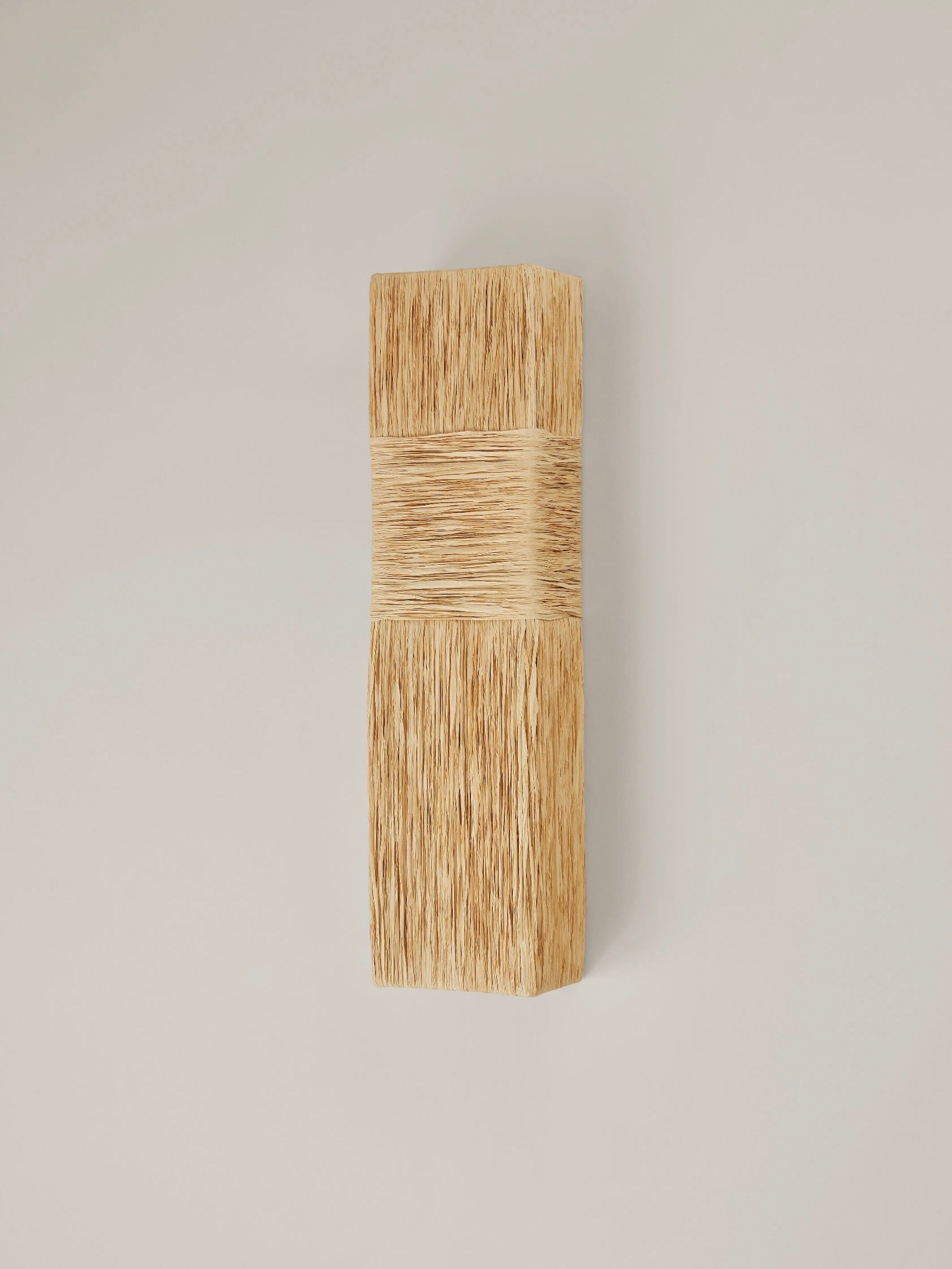 Eliane Wall Sconce in raffia — side angle showing textured surface