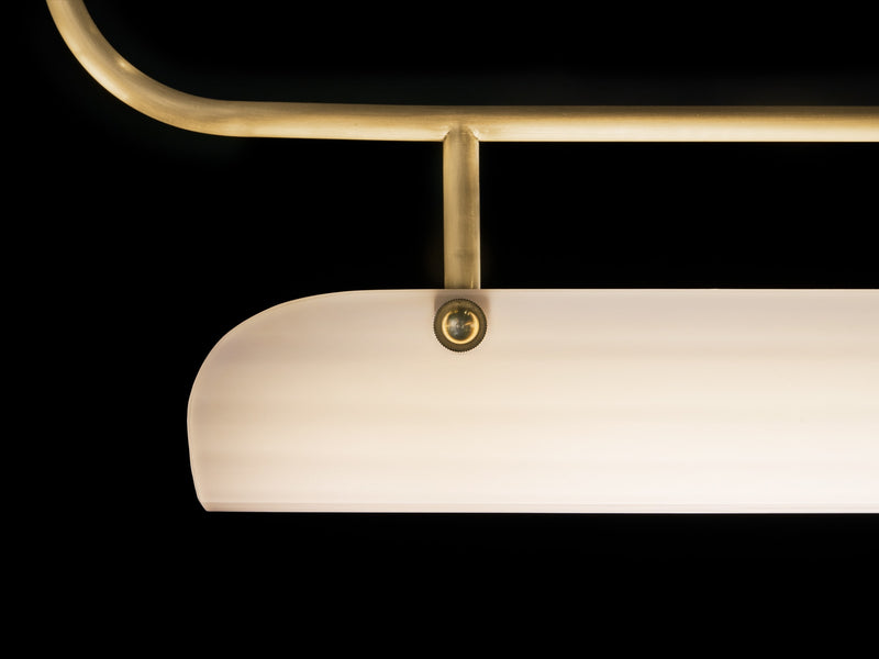 Eos quartz glass pendant lamp detail showing brass frame and fixture