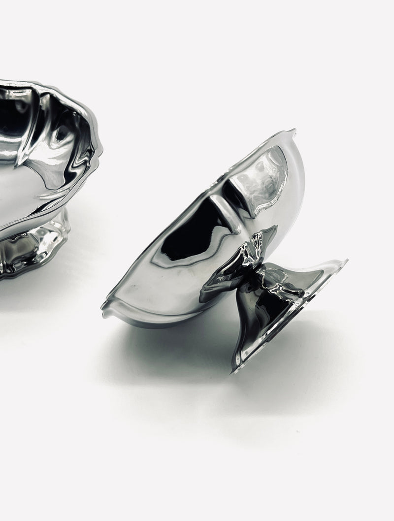 Stainless steel ice coupes showing curved sculptural forms