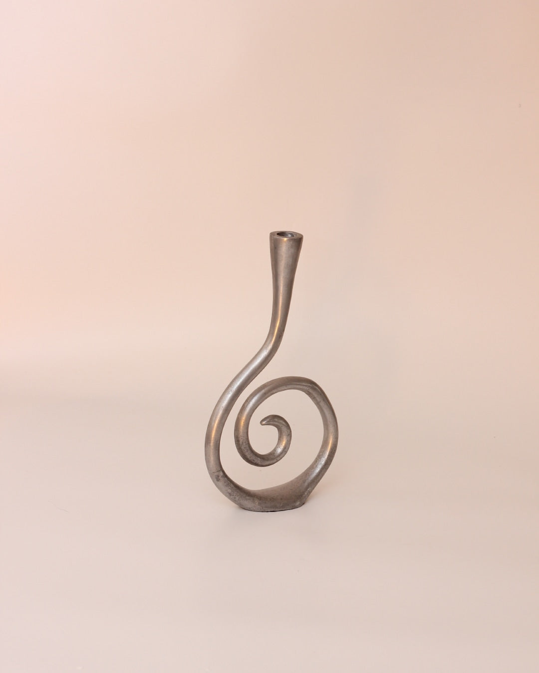 Candelabros Estaño — silver candle holder on neutral background