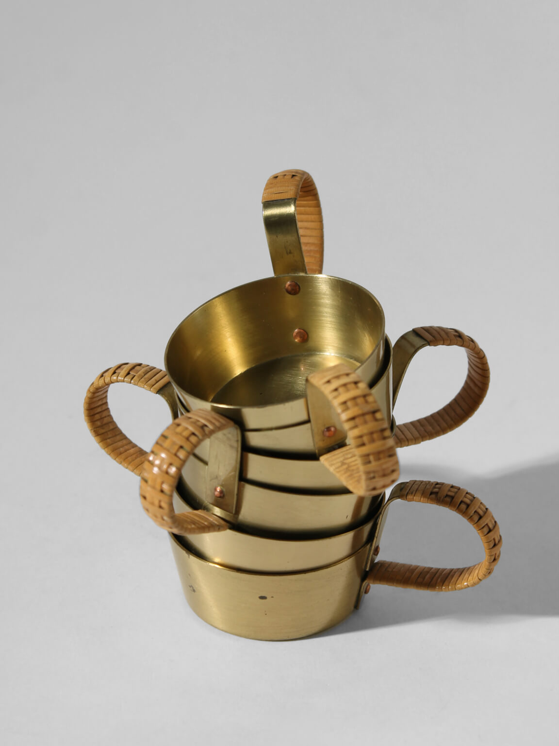 Albert Gustav Bunge Coffee Cups Set — side angle of brass cups with woven handles