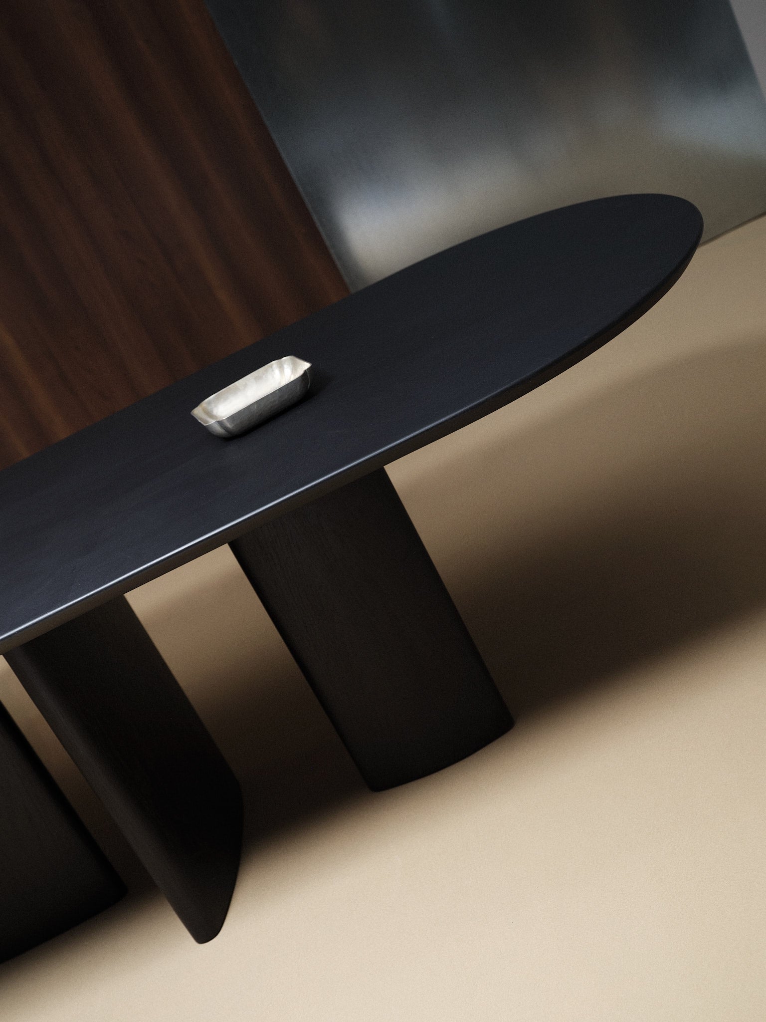 Valerie Dining Table — close-up of dark wood surface and pedestal base