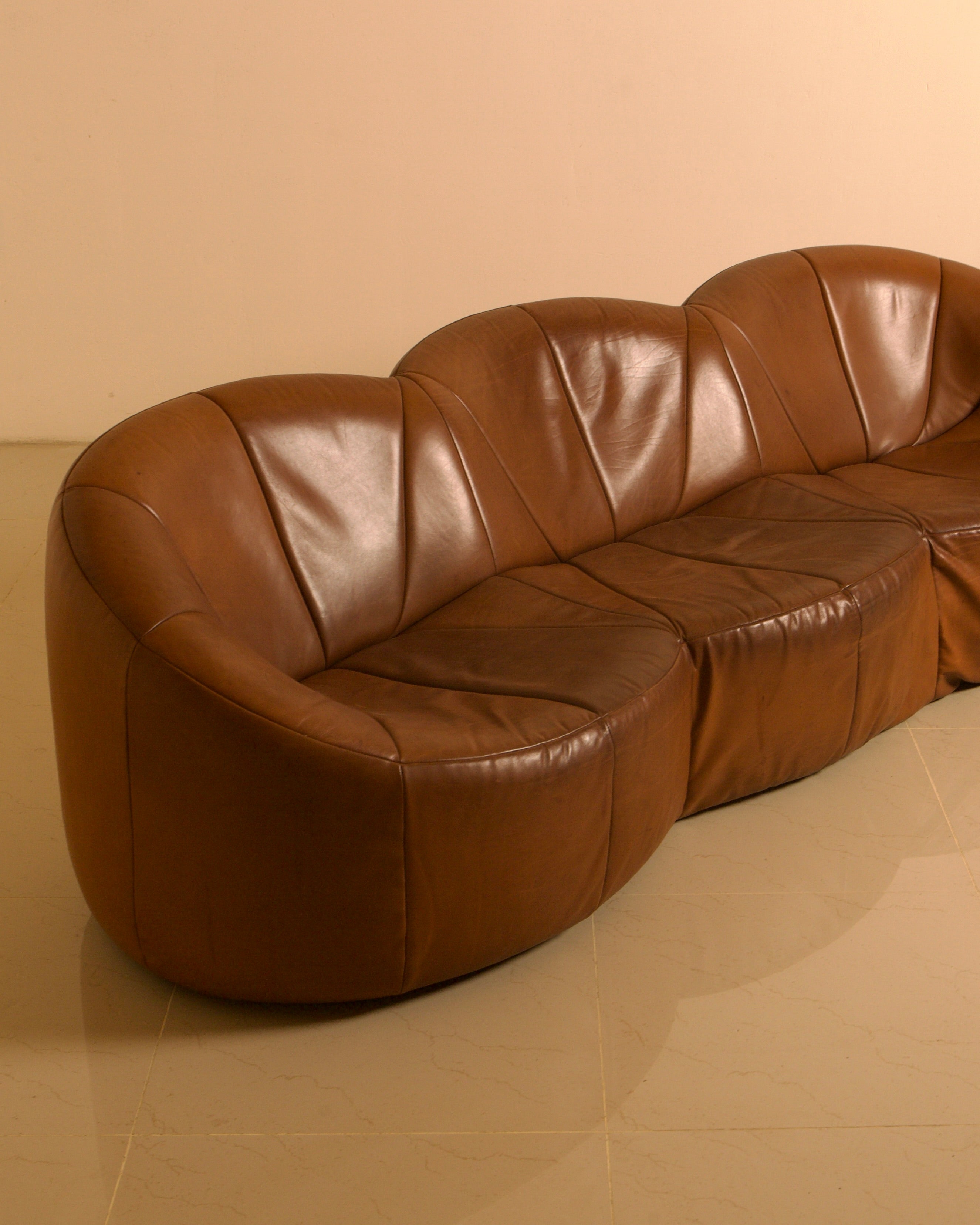 Three-seater "Pumpkin" Sofa by Pierre Paulin for Artifort, 1980 — angled view highlighting brown leather upholstery