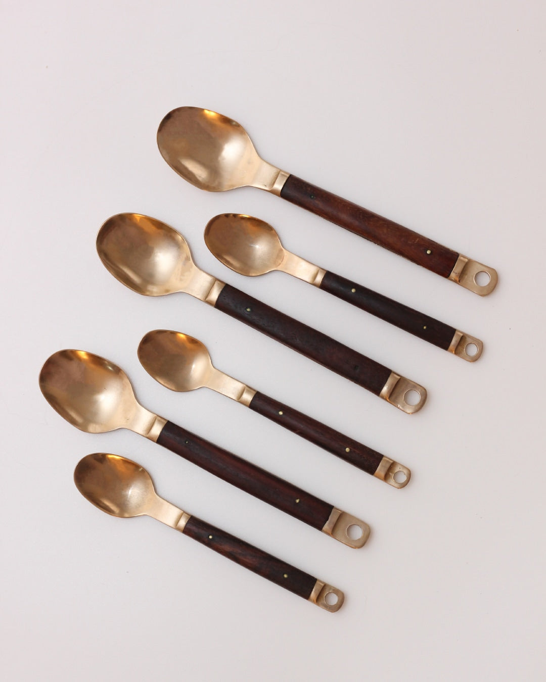 Cutlery Set — top view of brass and wood spoons
