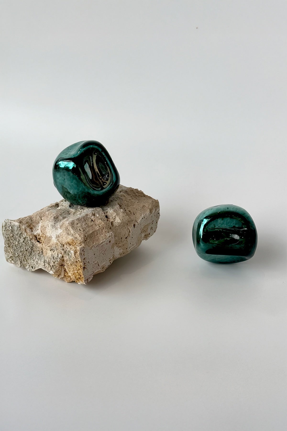 Knob Collection Sculptures in Glass — side view on textured stone base