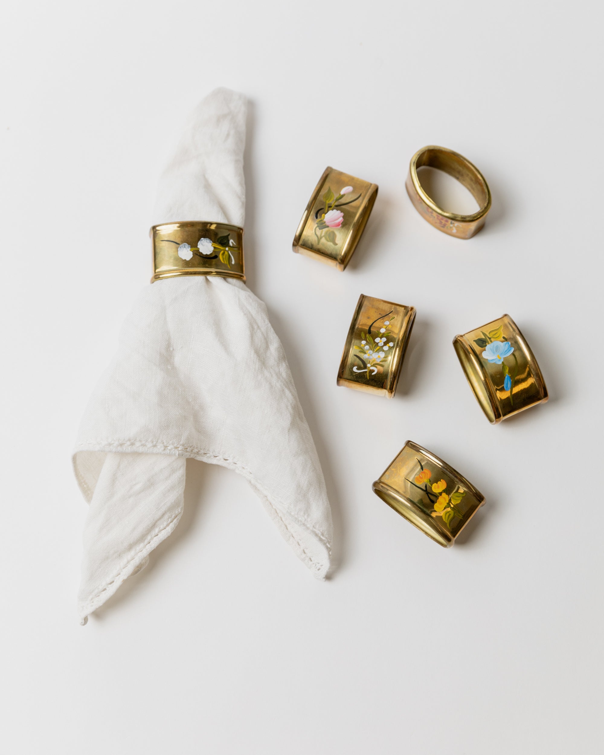 Set of six brass napkin rings with floral motifs, Italy 1940s