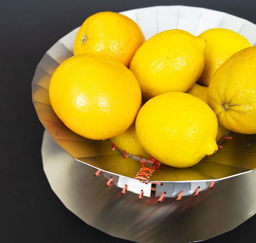 Mina - Centerpiece — top view of metallic bowl with lemons