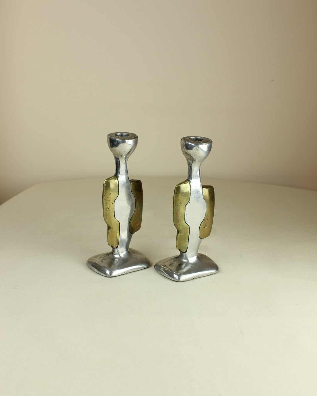 Brutalist Candleholders — top view of silver and brass design