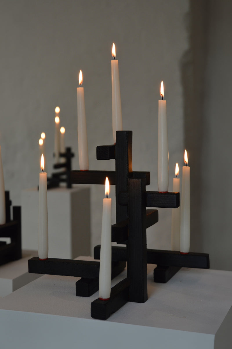 Black geometric Tetris 7 candleholder with lit white candles