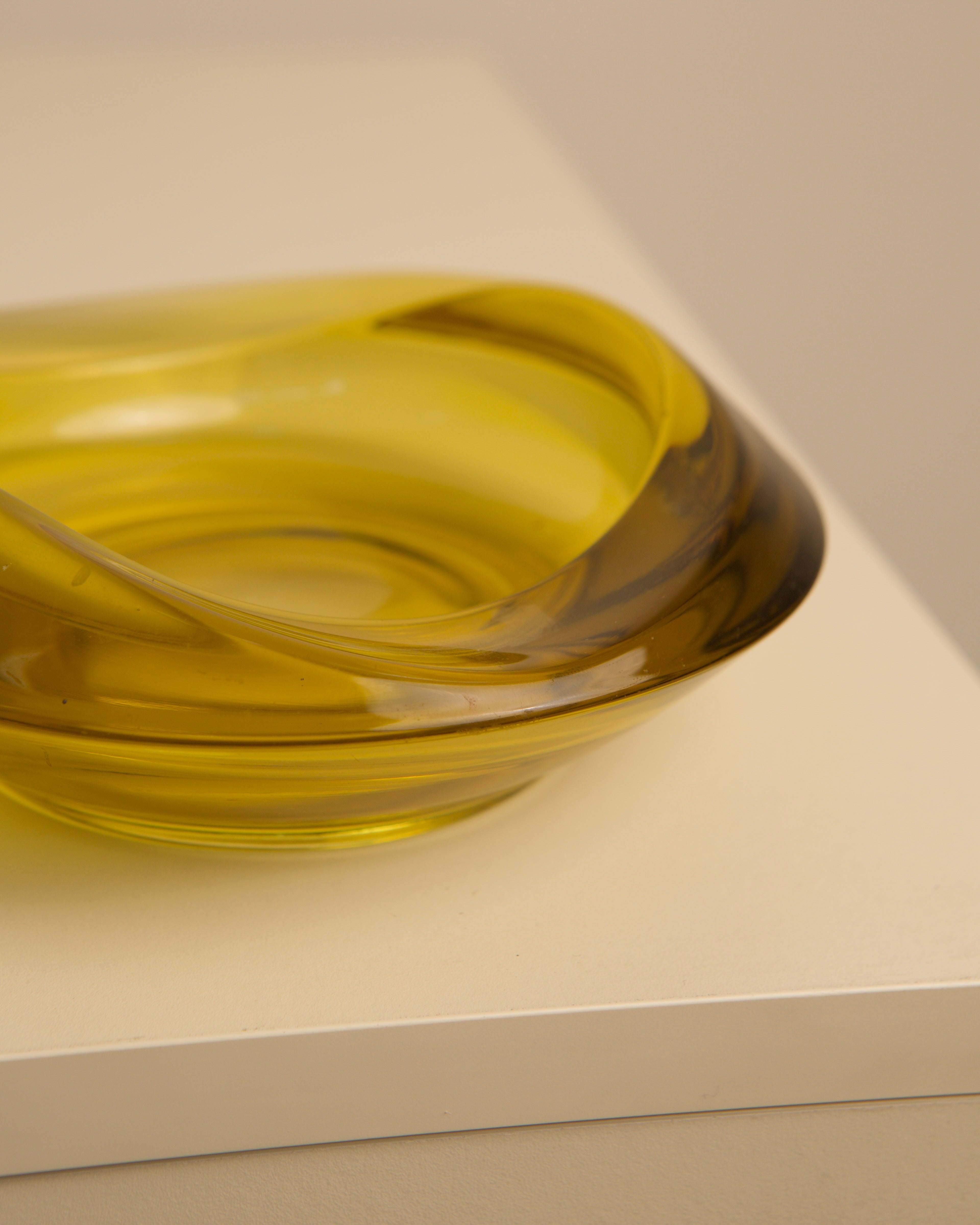 Close-up detail of circular yellow Murano glass vide-poche bowl