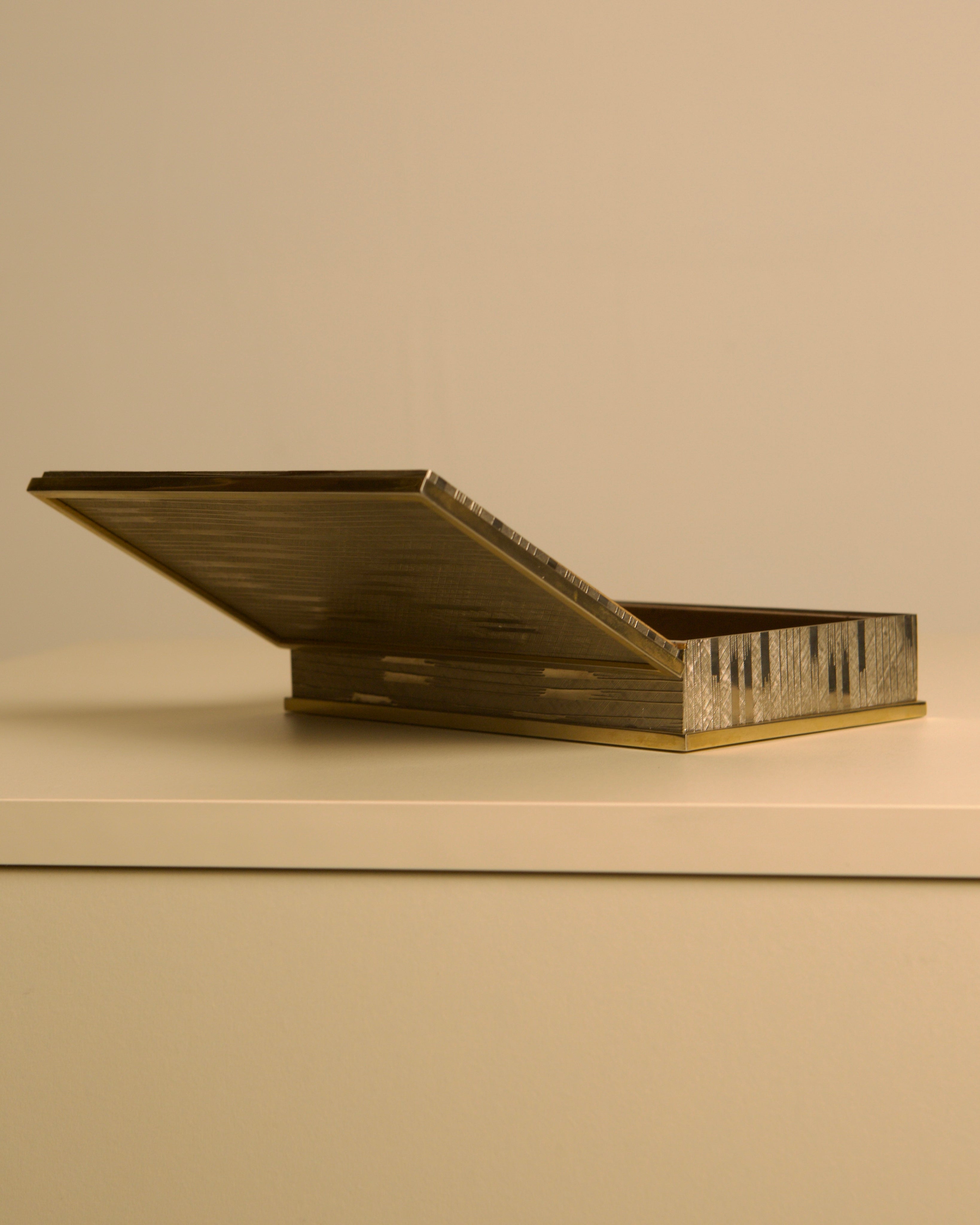 Italian Art Deco Box in Cut Metal and Brass, 1930s — top view with open lid on neutral surface