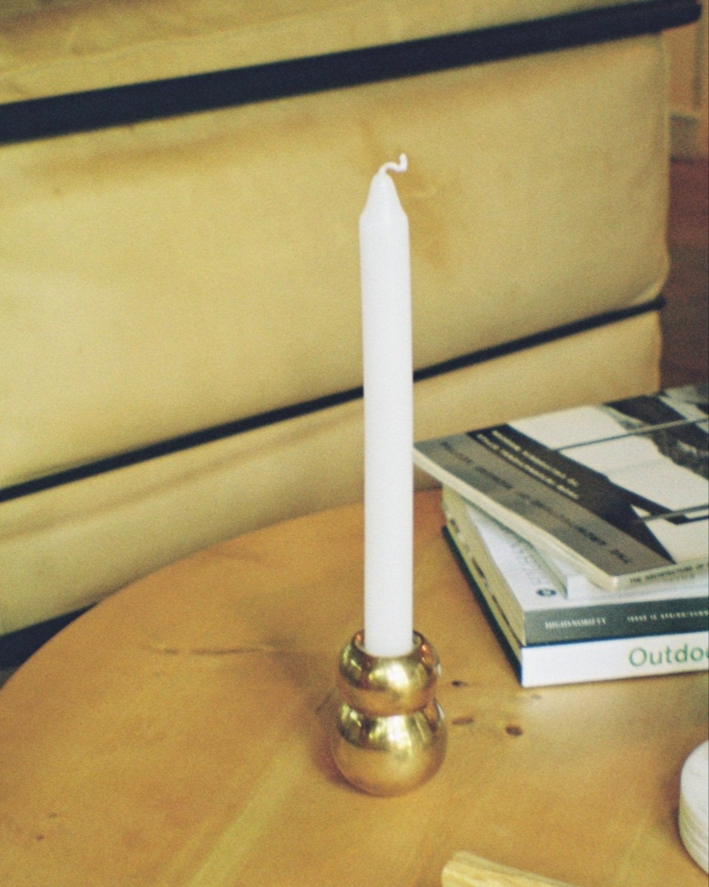 ANJOU Candleholder — close-up of brass base with white candle