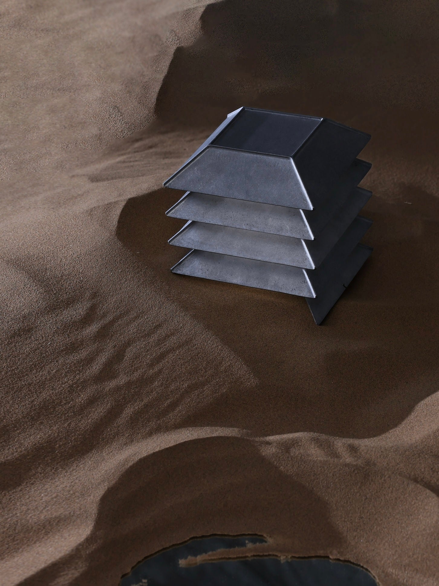 Pagoda Table Lamp — close-up of layered metal design on sand