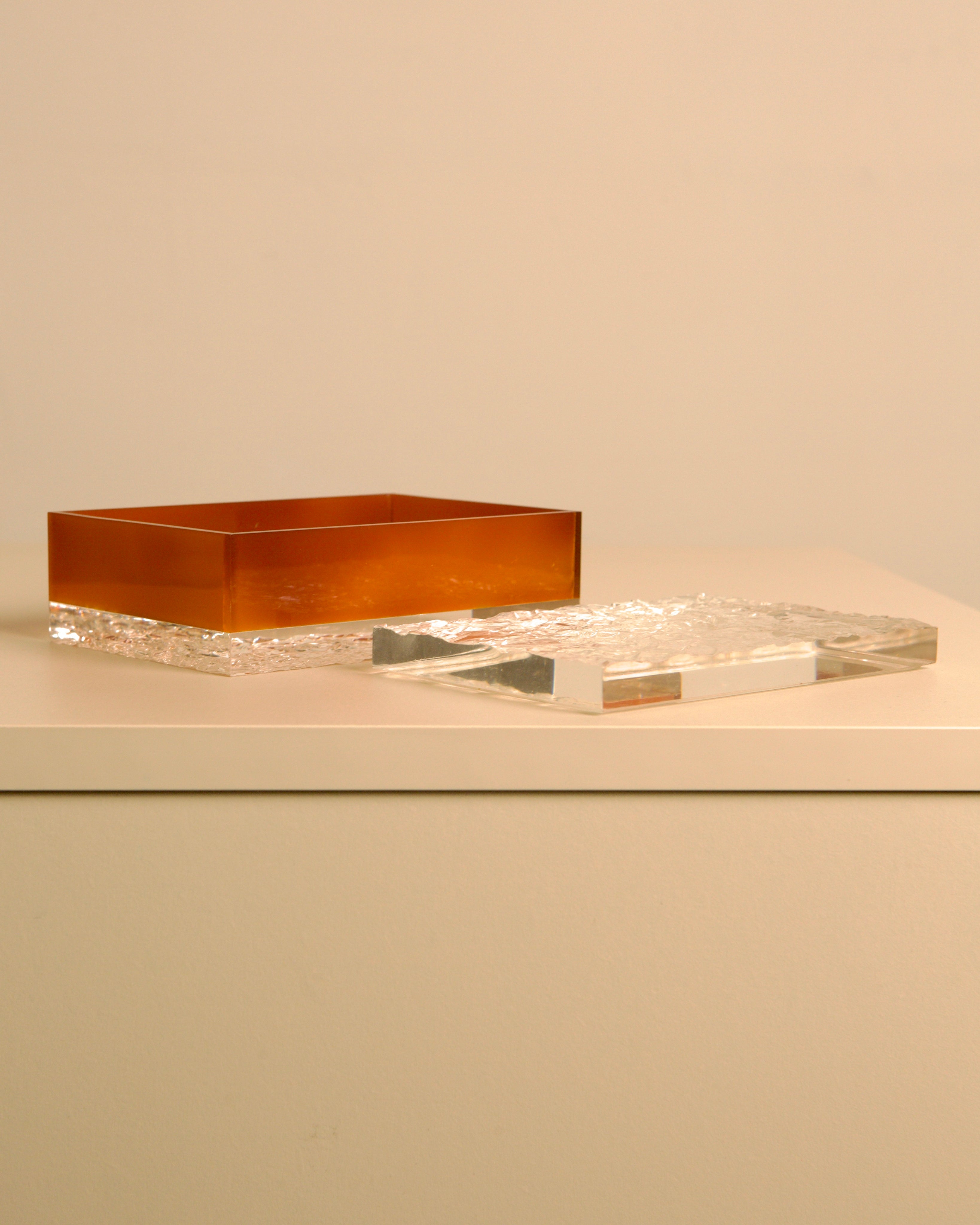 Italian Box in Smoked Plexiglass — top view of amber and clear boxes on white surface