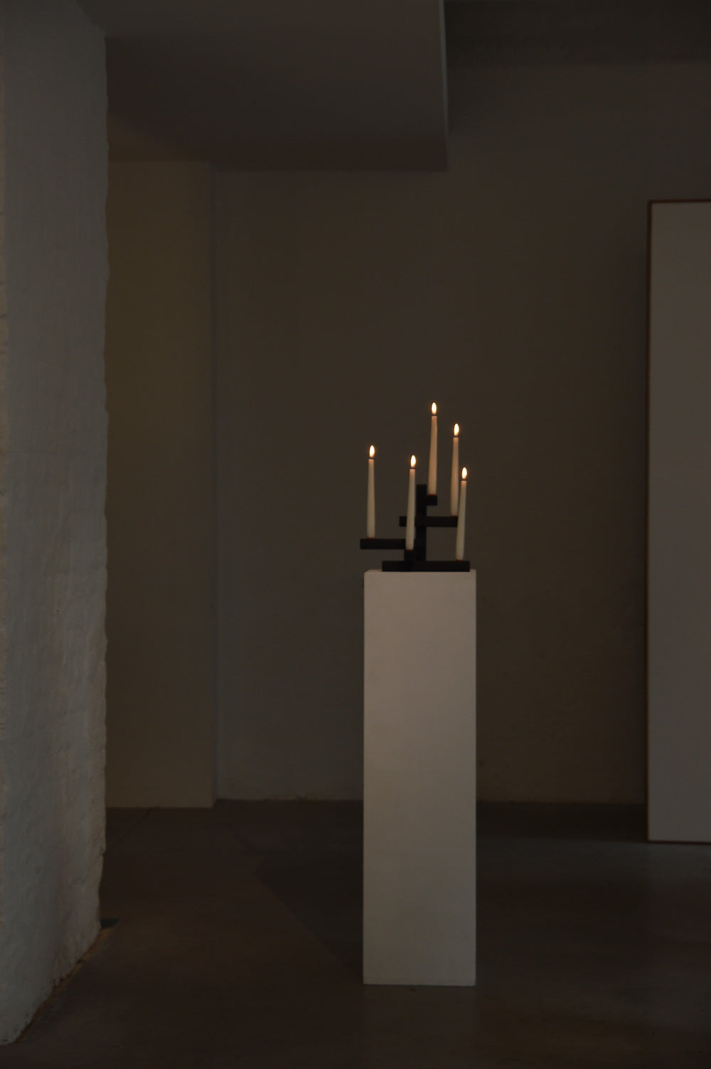 TETRIS 5 — candle holders on white pedestal in minimalist setting