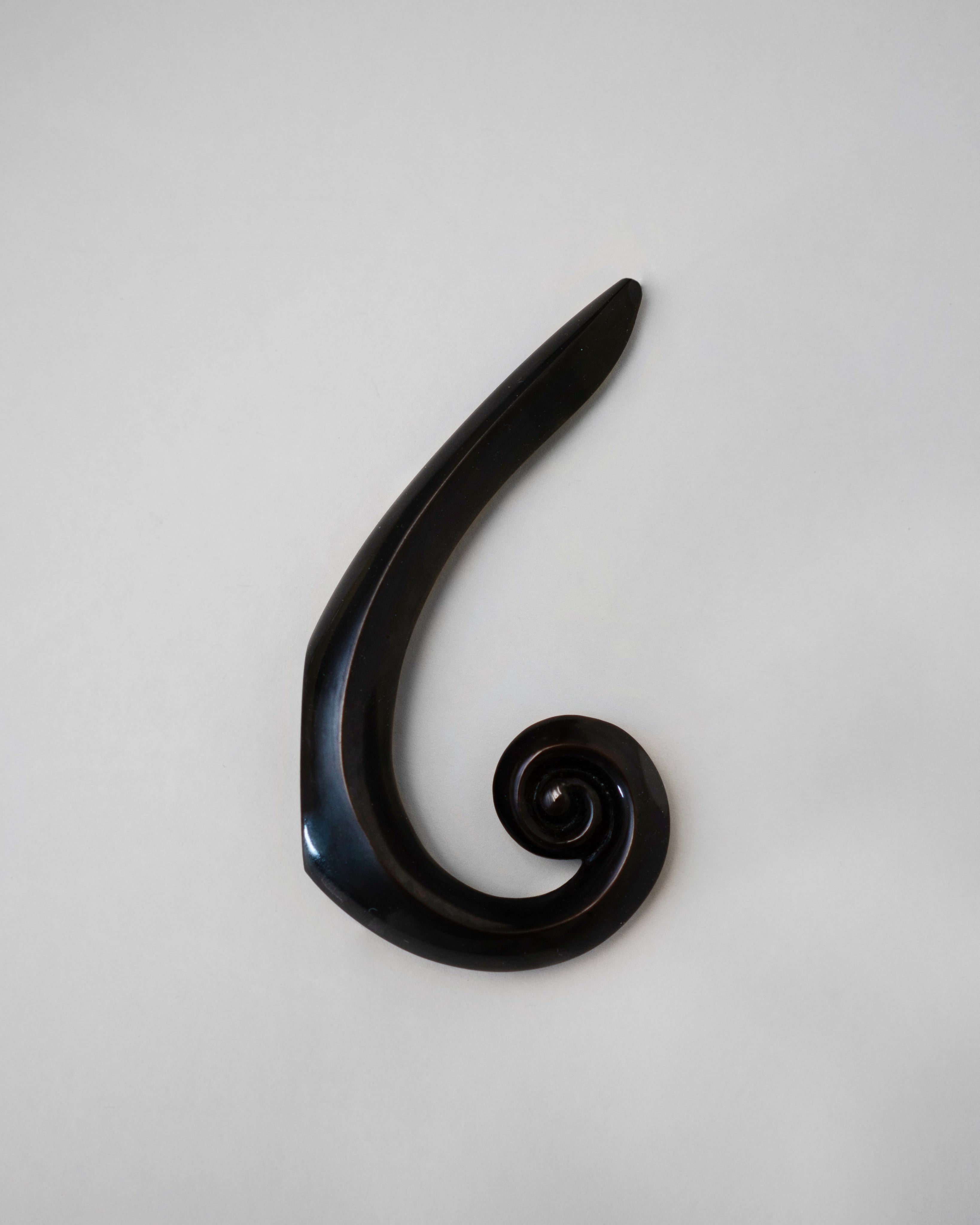 Noelle Hook - Antique Brass — top view of curved brass design