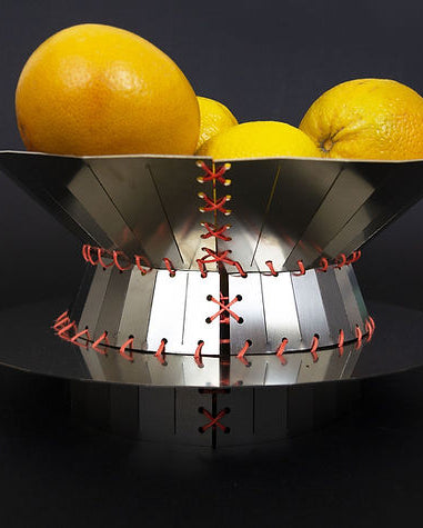 Mina - Centerpiece — close-up of metallic bowl with orange stitching