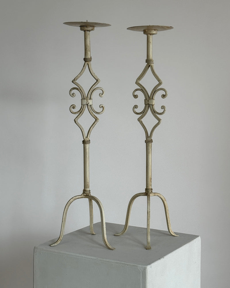 Pair of tall antique white metal candlesticks with ornate scrollwork