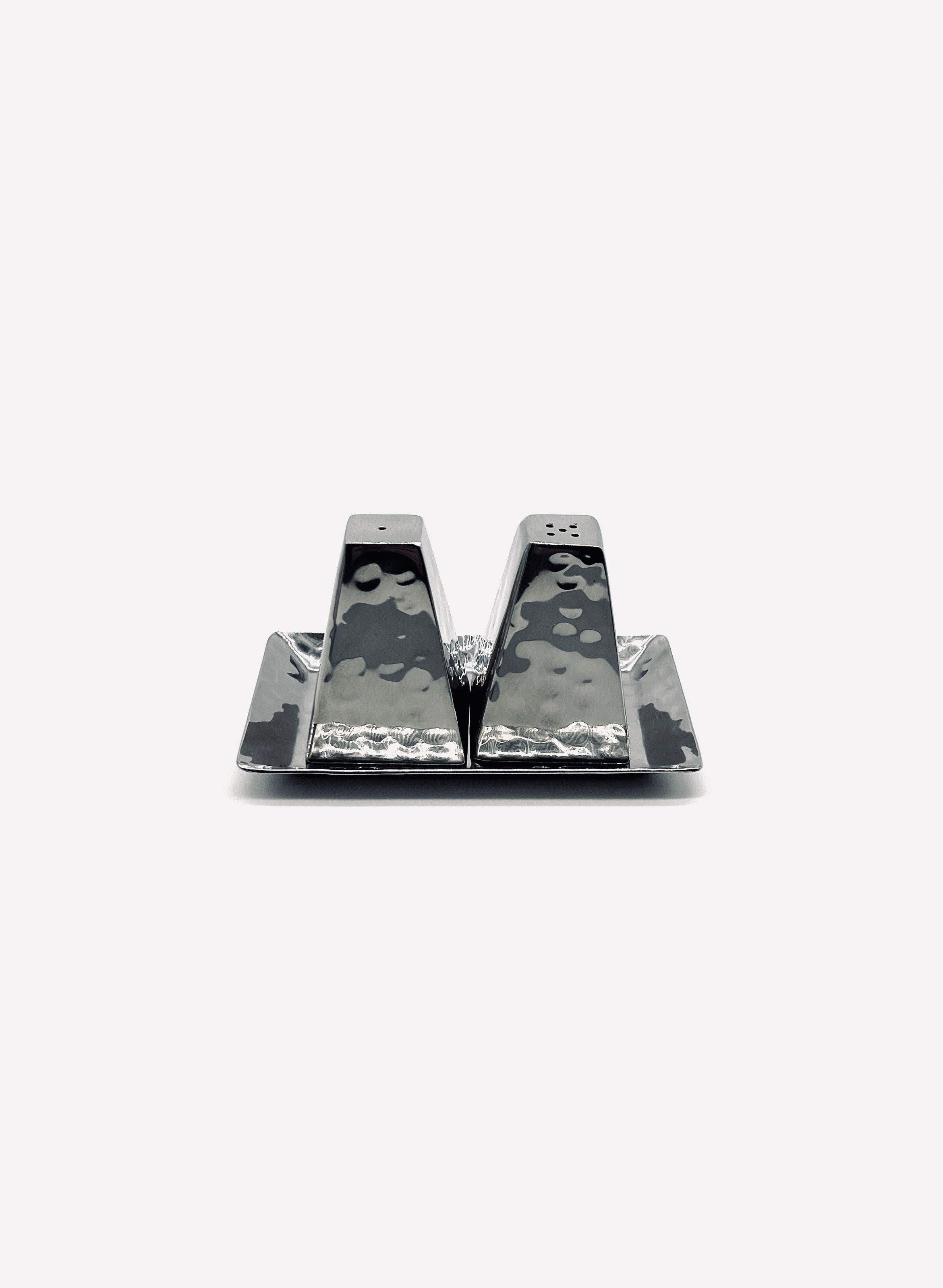 Vintage stainless steel salt and pepper shakers on matching tray