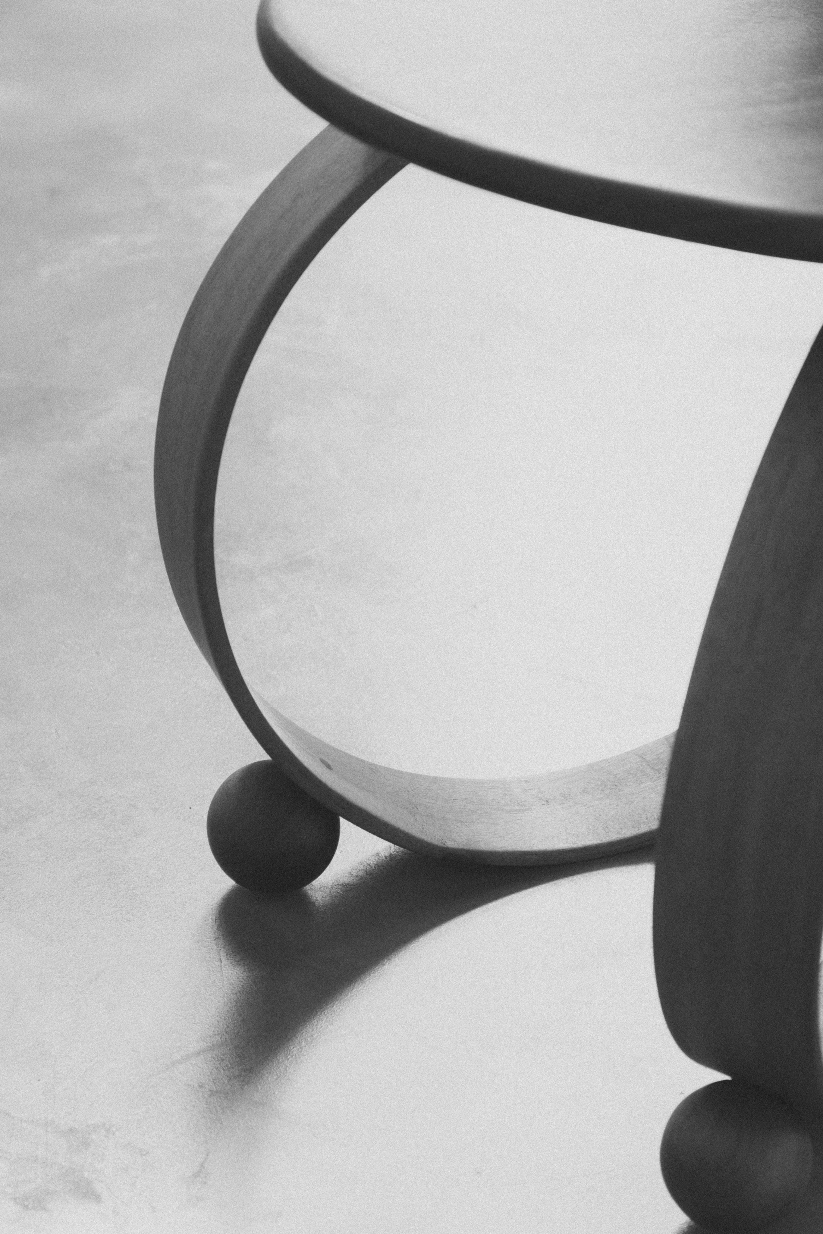 Yara' Chair — back view highlighting curved wooden legs