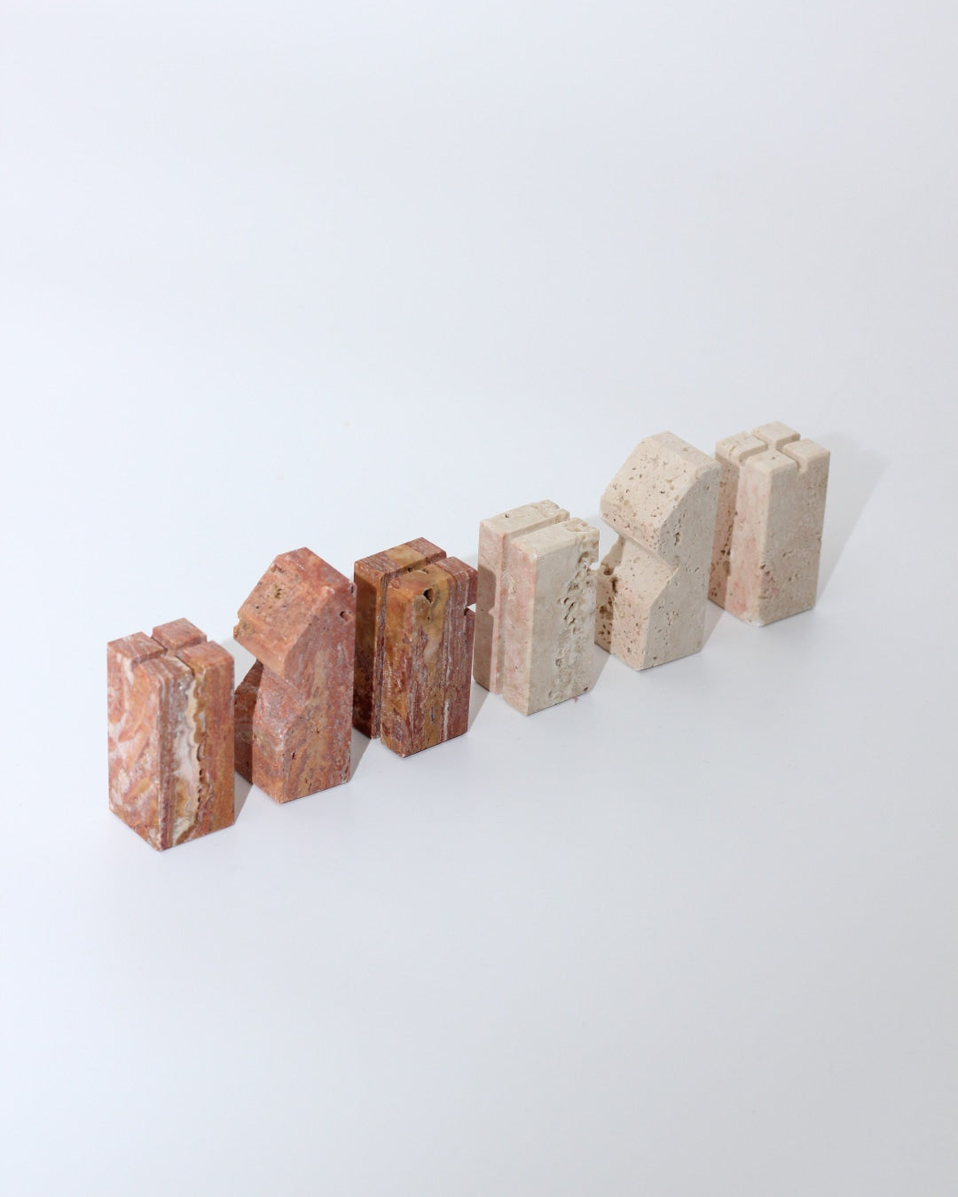 Modernist Chess Set — angled view of marble pieces in neutral tones