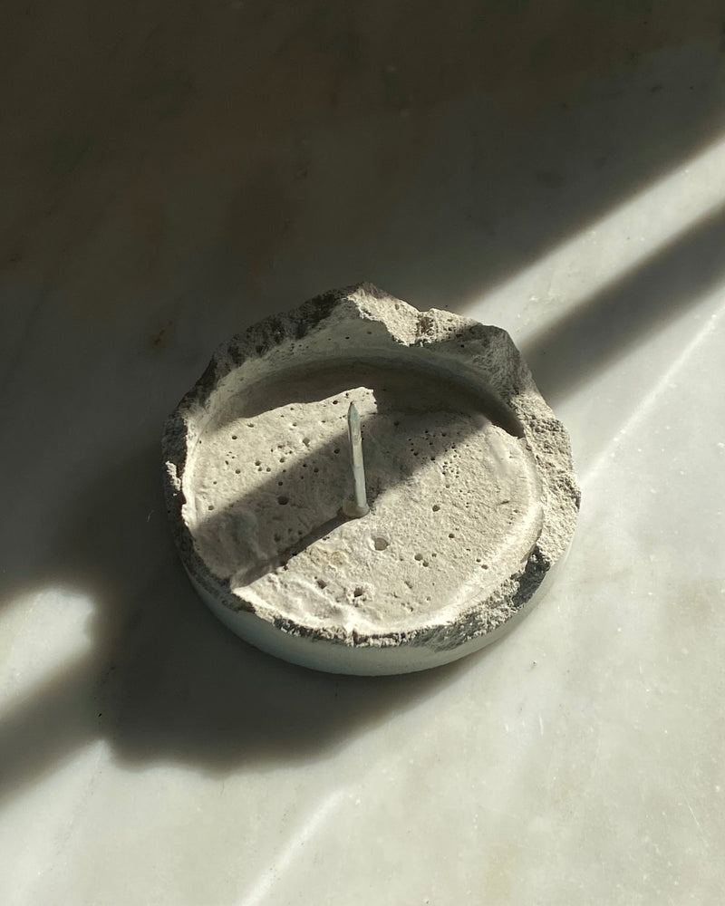 Lotus cement candle holder detail showing textured surface and wick