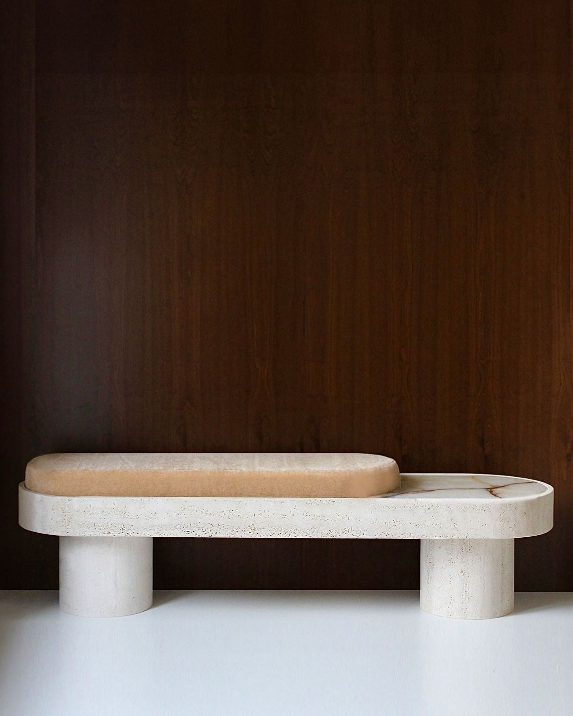 Noto Bench — side angle showing light stone base and soft cushion