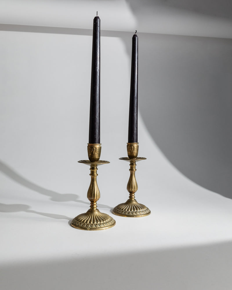 Pair of 1930s brass candlesticks with black taper candles