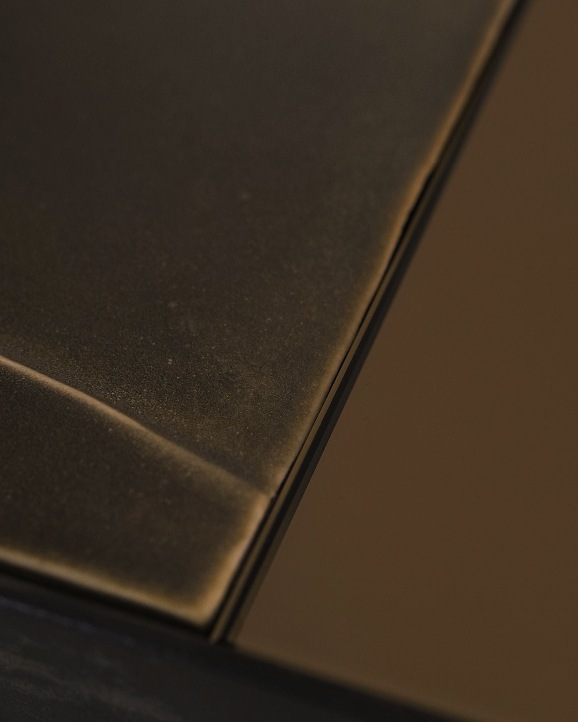 GIO I mirror corner detail showing bronze frame texture