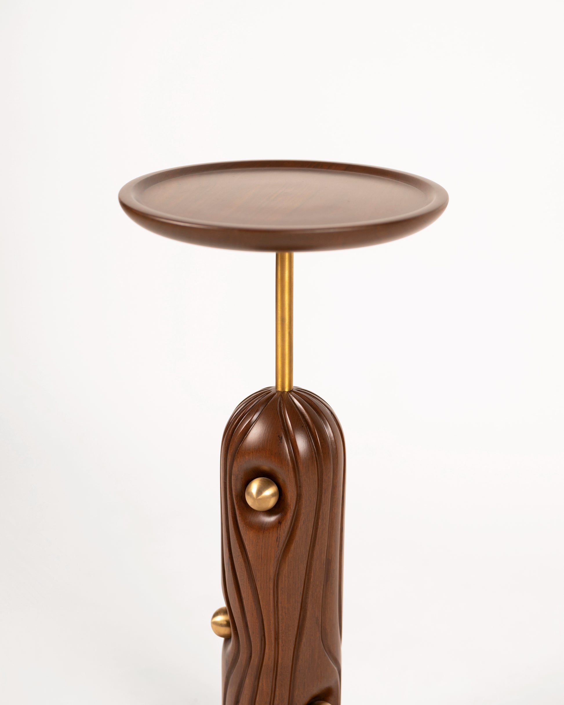 Linea Cocktail Table — close-up of wooden base with brass accent