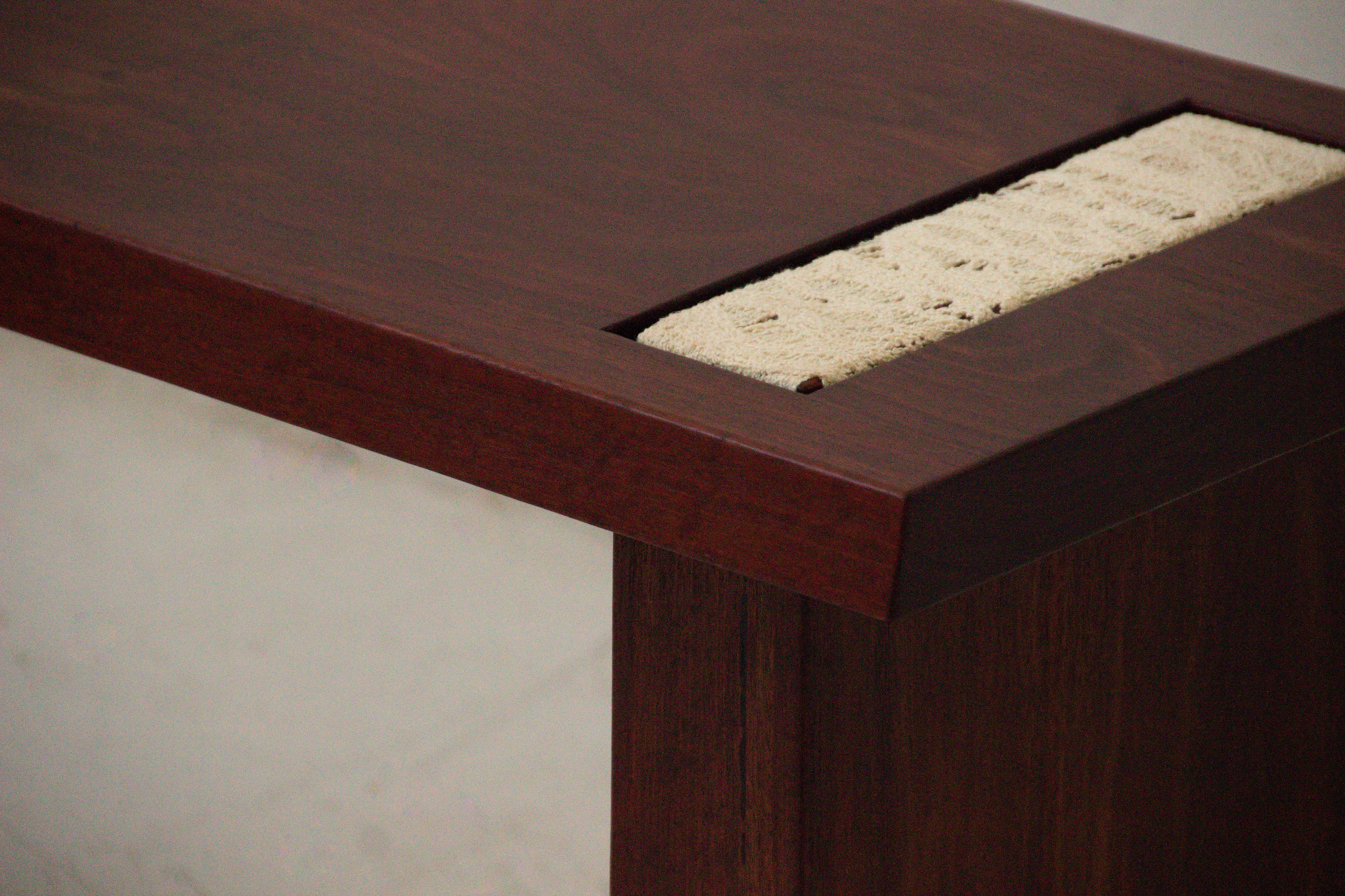 Bench — side angle showing rich wood finish and textured surface