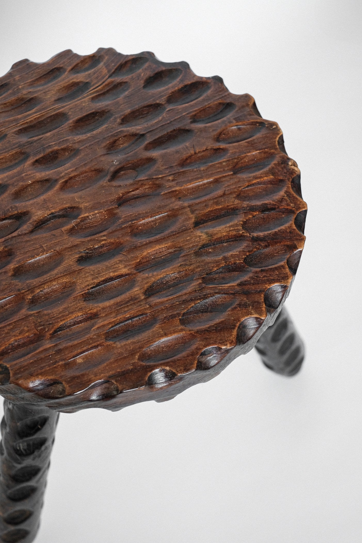 Hand-carved Wooden Tripod Stool — close-up
