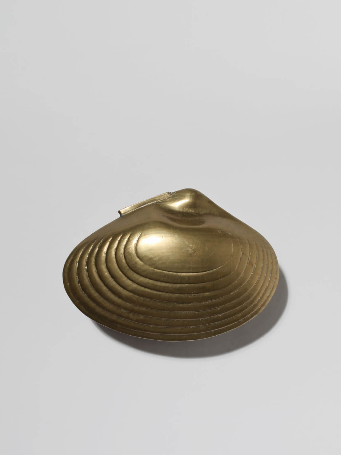 Brass Clamshell Trinket Box — top view showing ridged brass surface