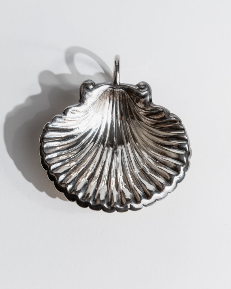 Silver shell-shaped serving bowl with ribbed texture detail