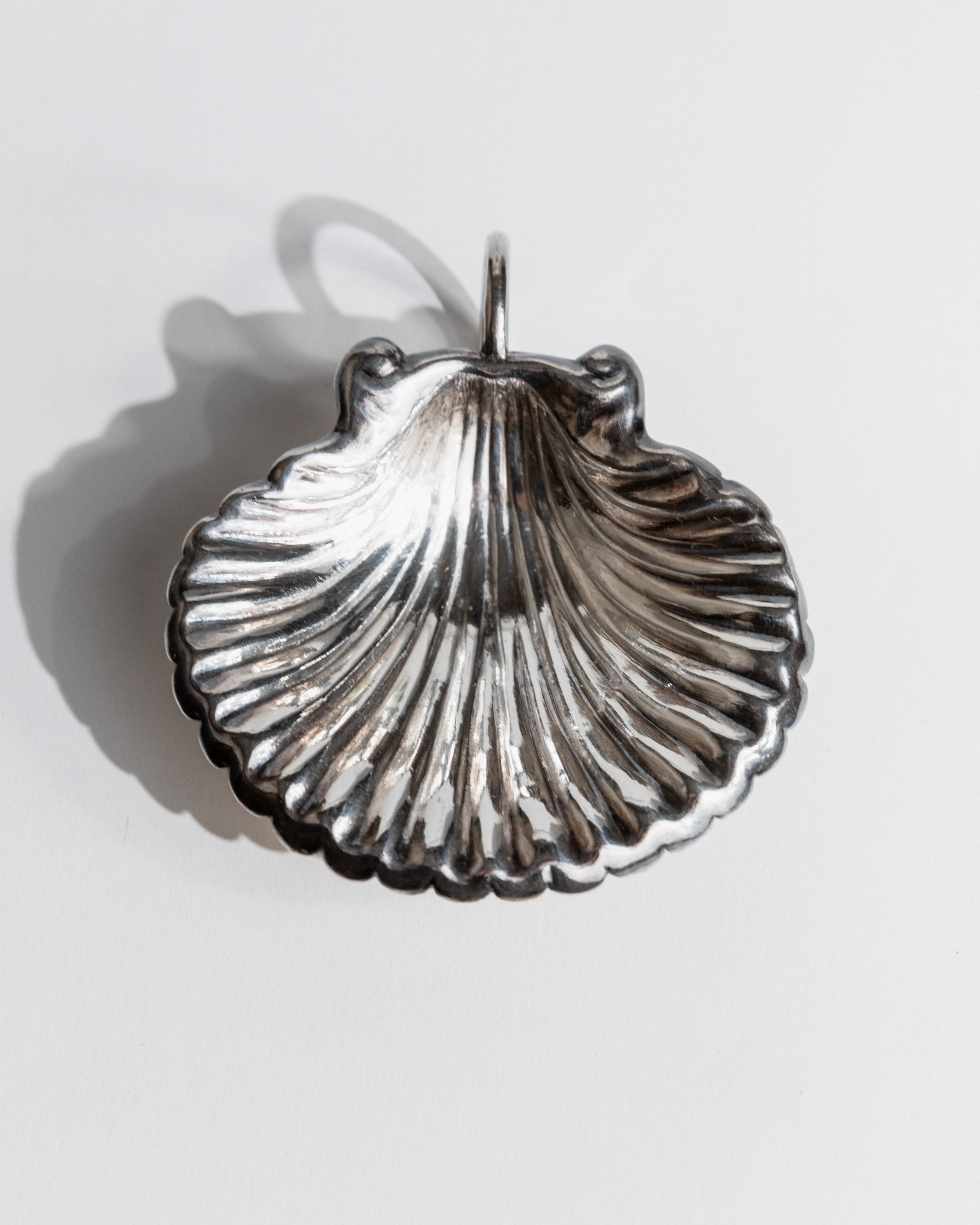 Silver shell-shaped serving bowl with ribbed texture detail
