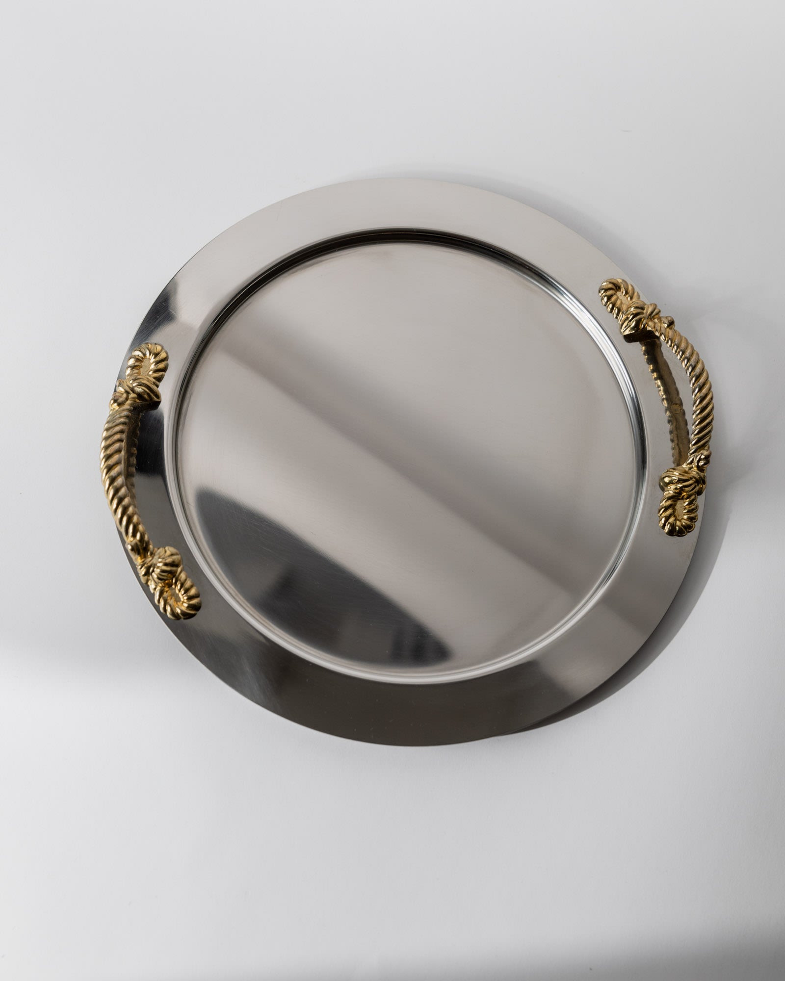 Vintage 1980s Stainless Steel Tray round, Gold Rope Handles by Inoxpran Italy — top view on white background