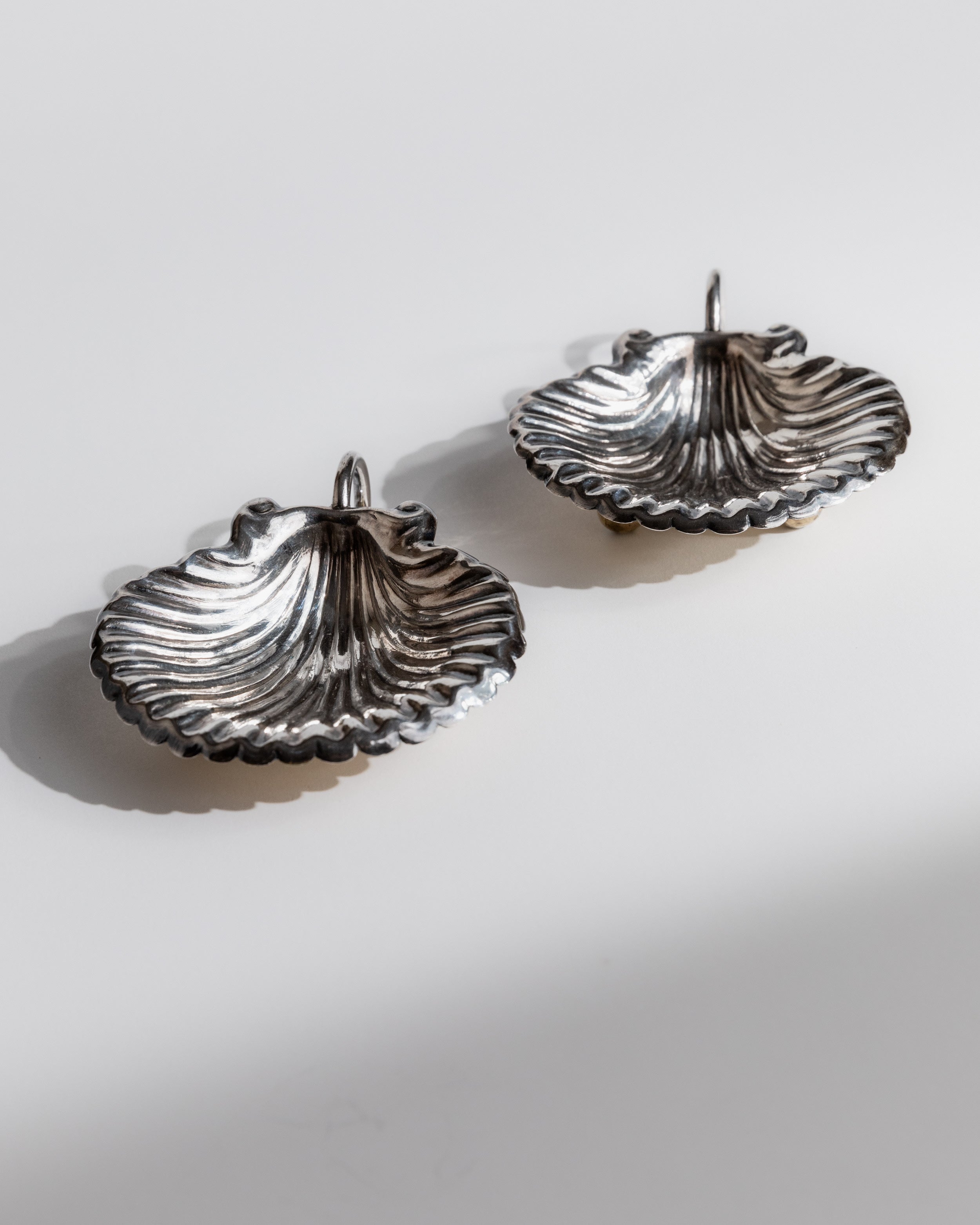 Two polished silver shell-shaped serving bowls from 1960s