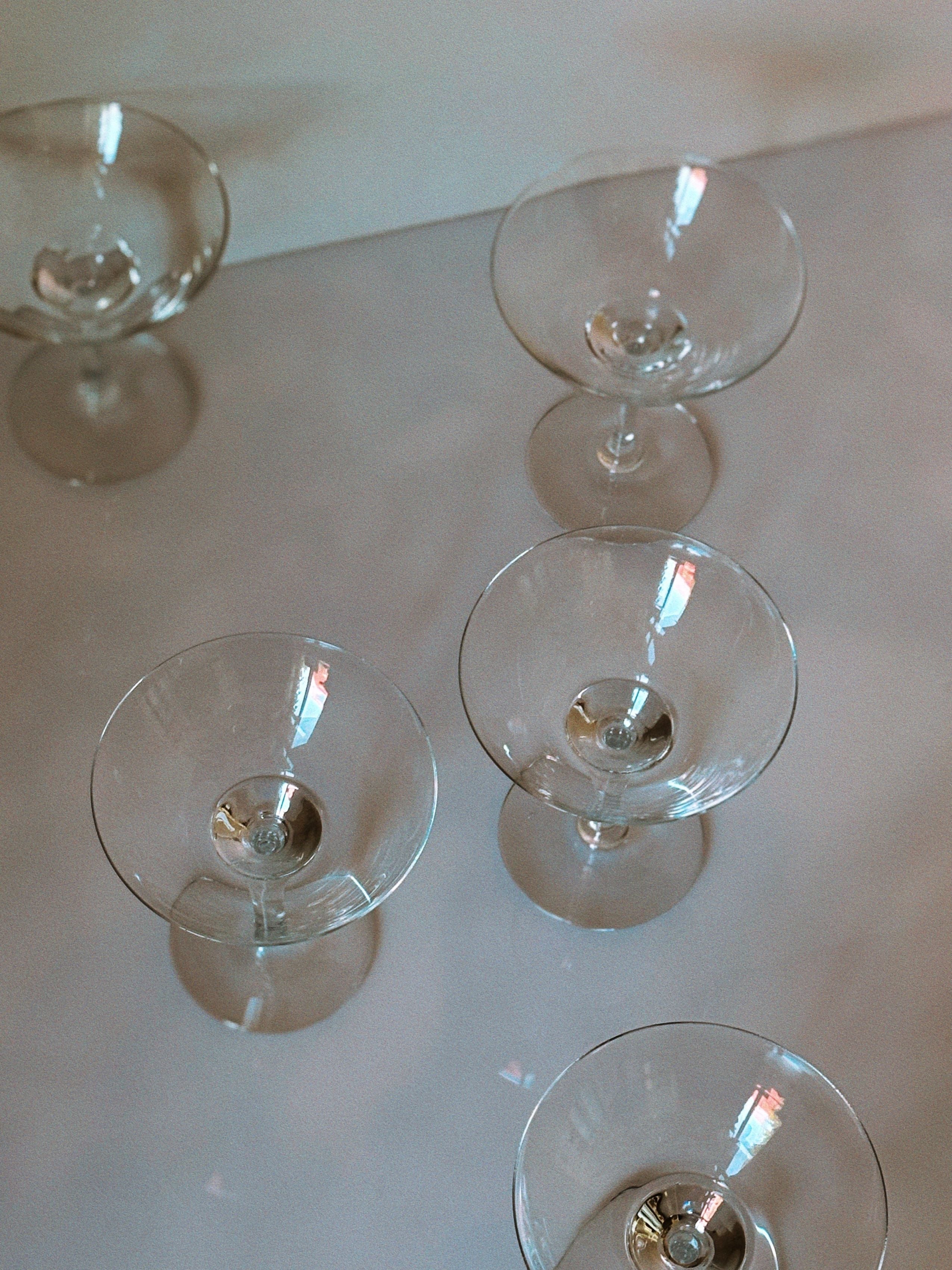 Art Deco cocktail glasses viewed from above on marble surface