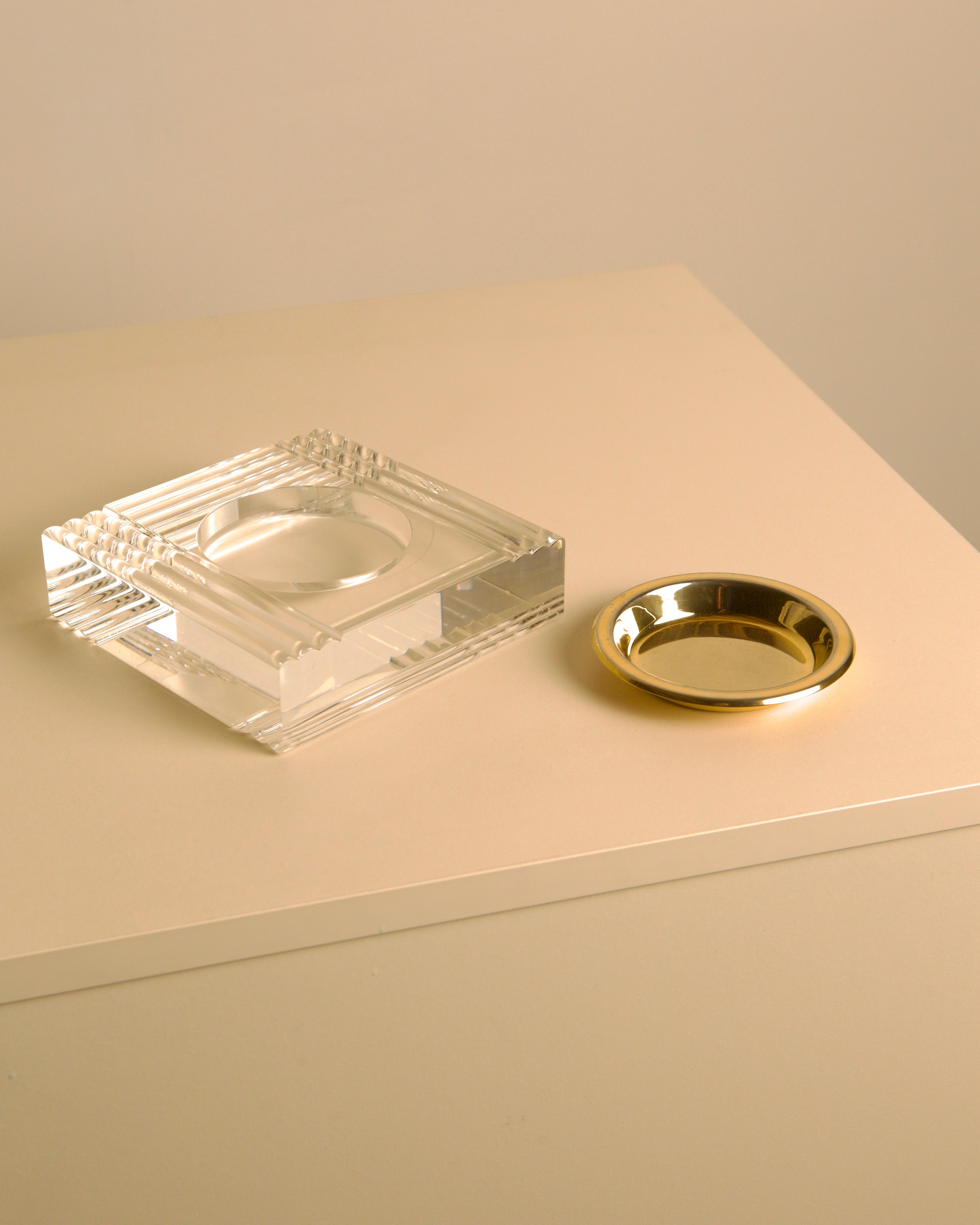 Square Italian trinket tray in lucite and brass, 70s — top view on neutral surface