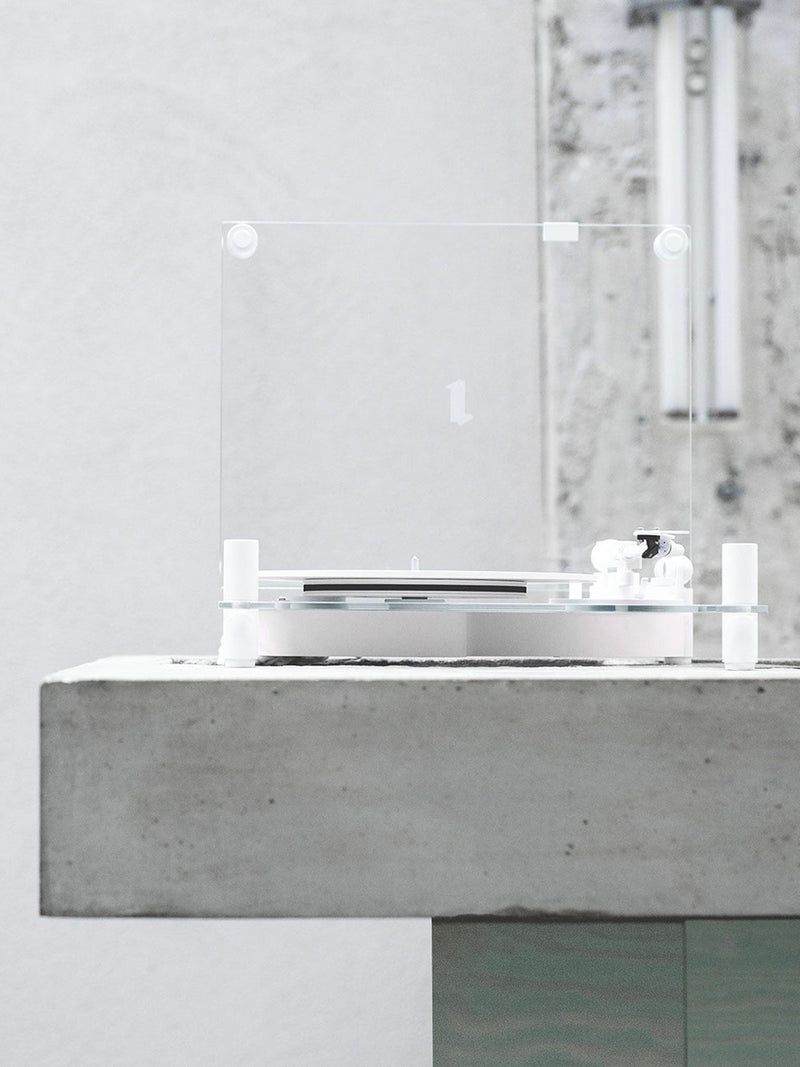 Transparent Turntable White - Bluetooth — side view on concrete surface