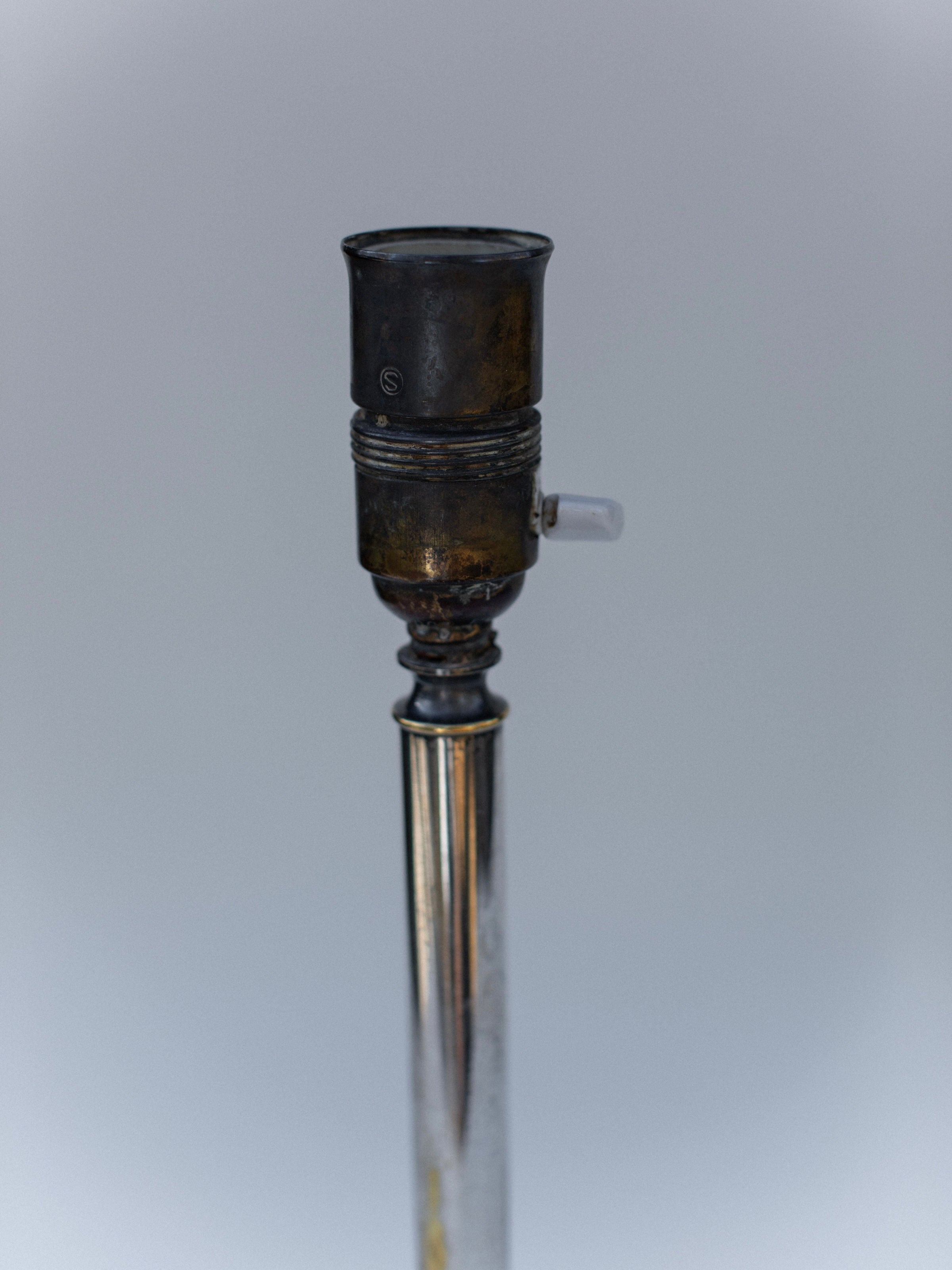 Close-up detail of 1920s Swedish Grace lamp socket and brass stem