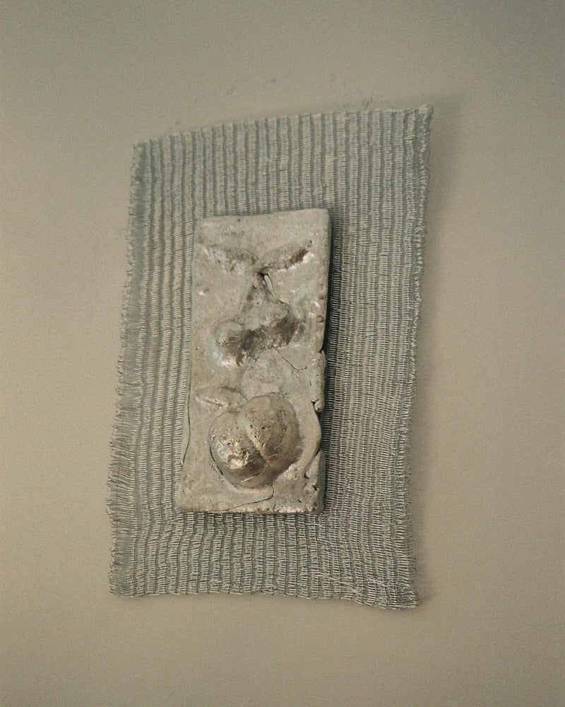 Contemporary textured wall sculpture with organic forms in neutral tones