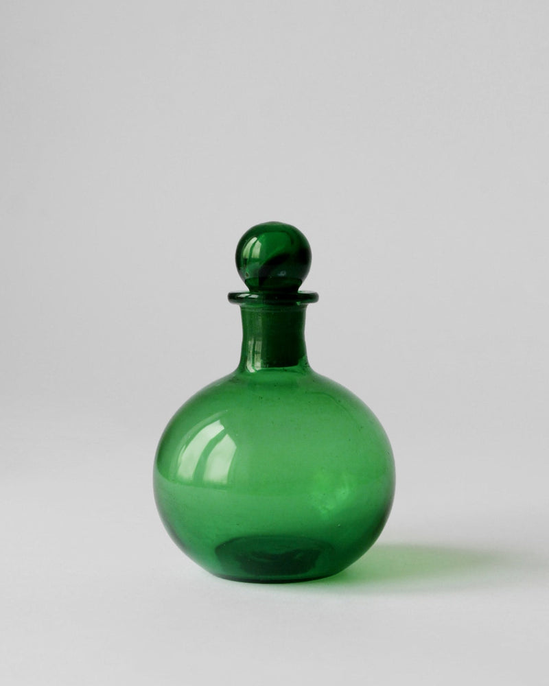 Emerald green vintage glass perfume bottle with round stopper