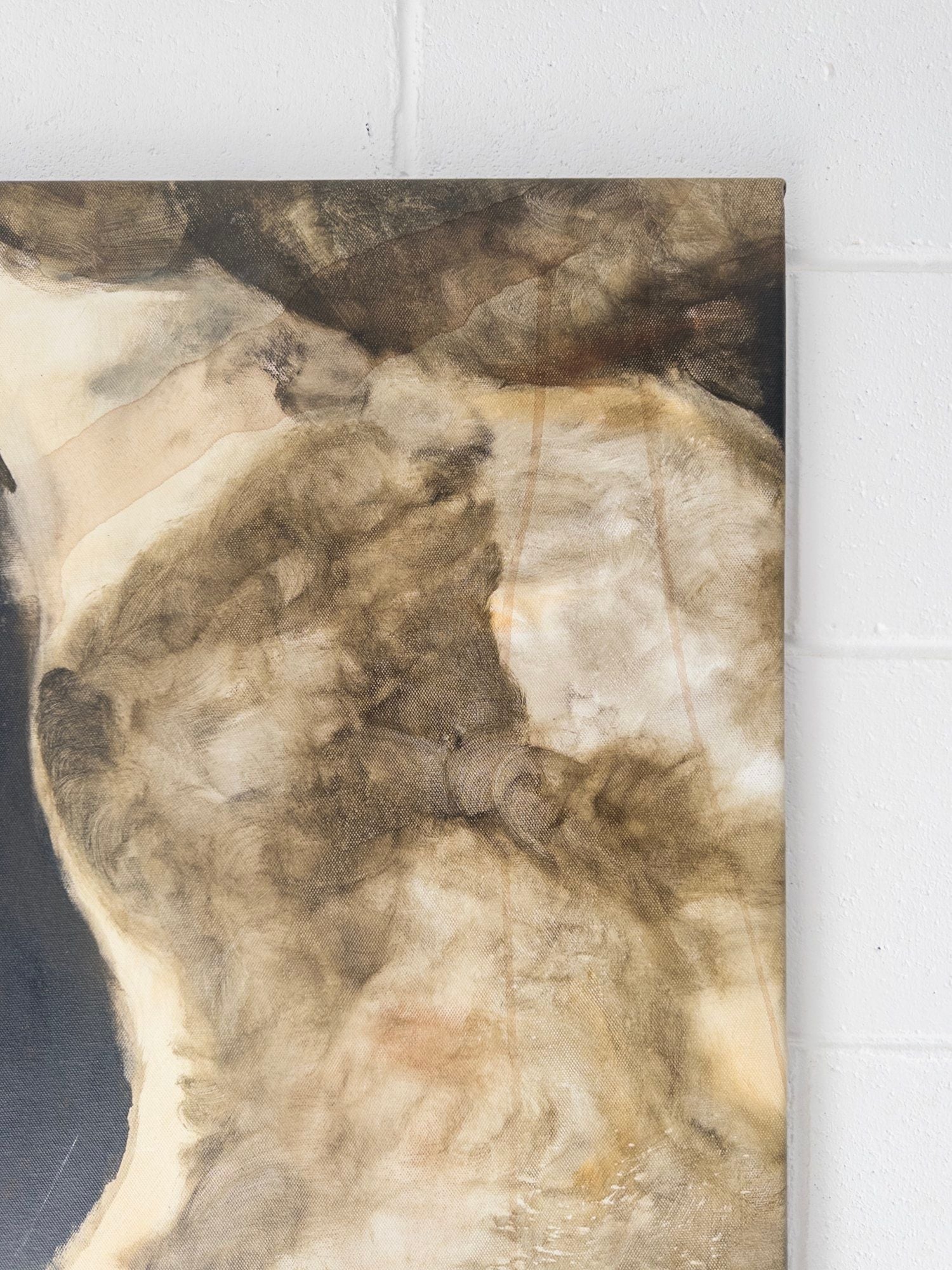 A close-up of Natasha France’s 'Nightfall Over Olympia' Mixed Media highlights earthy brown, beige, and cream cloud-like textures on canvas, set against a white cinder block wall.